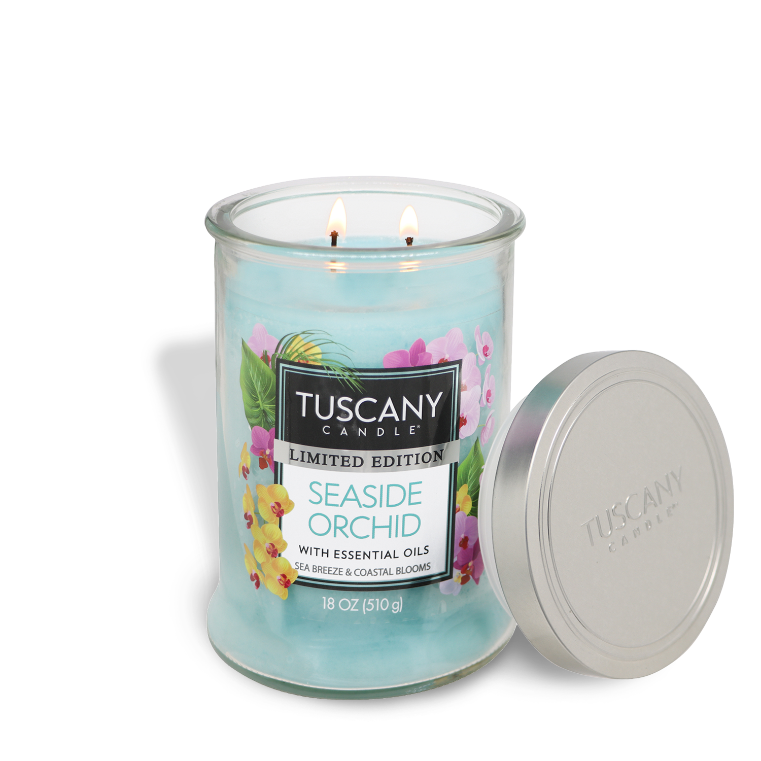 A lit Tuscany Candle® SEASONAL Seaside Orchid: Sea Breeze & Coastal Blooms Scented Spring Candle (18 oz) with blue wax, essential oils, floral label, and silver lid stands next to the coastal scented candle.