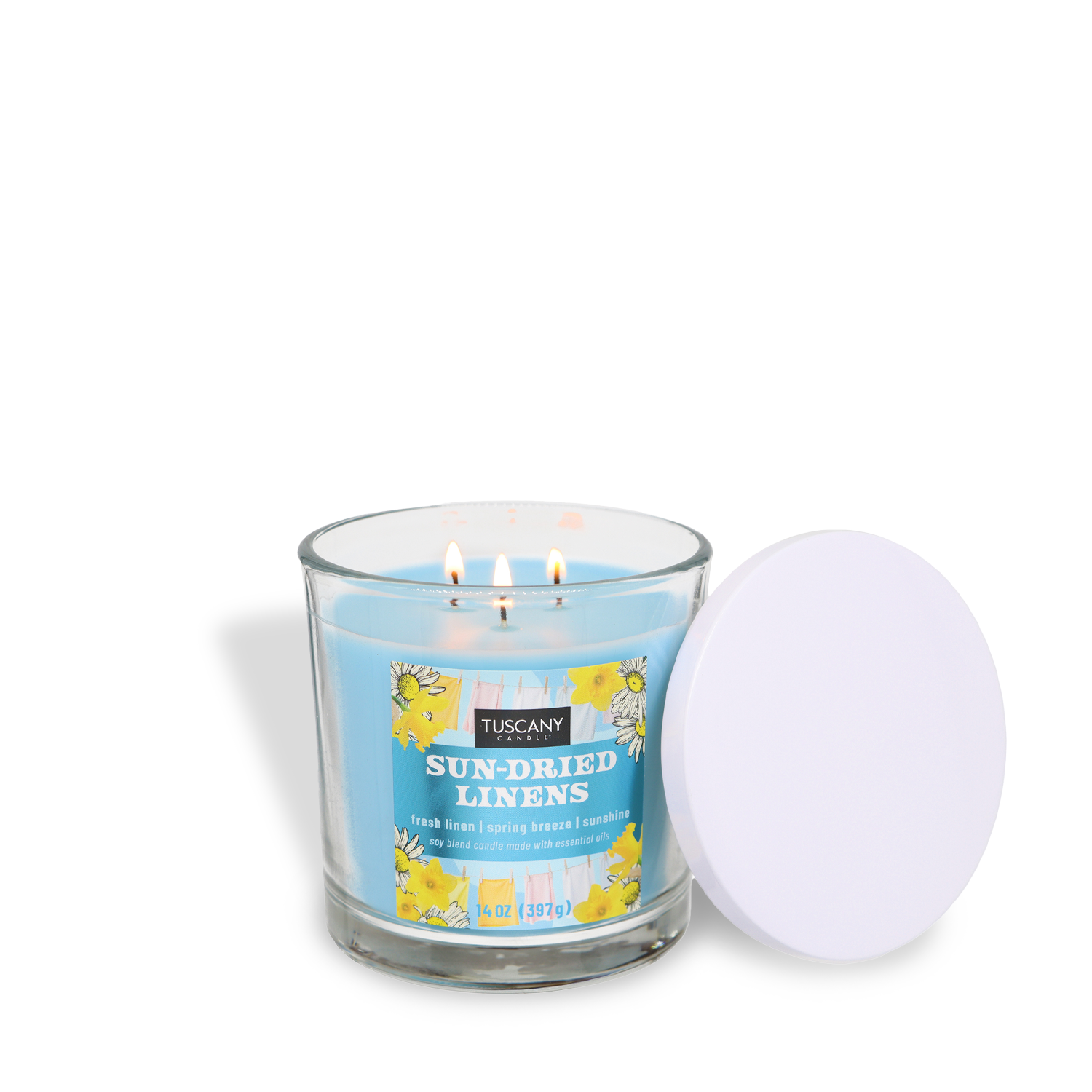 A lit Tuscany Candle® SEASONAL "Sun-Dried Linens: Sunshine & Breeze Scented Spring Candle" (14 oz) with a blue hue, yellow floral design, and white lid sits in a clear glass jar.