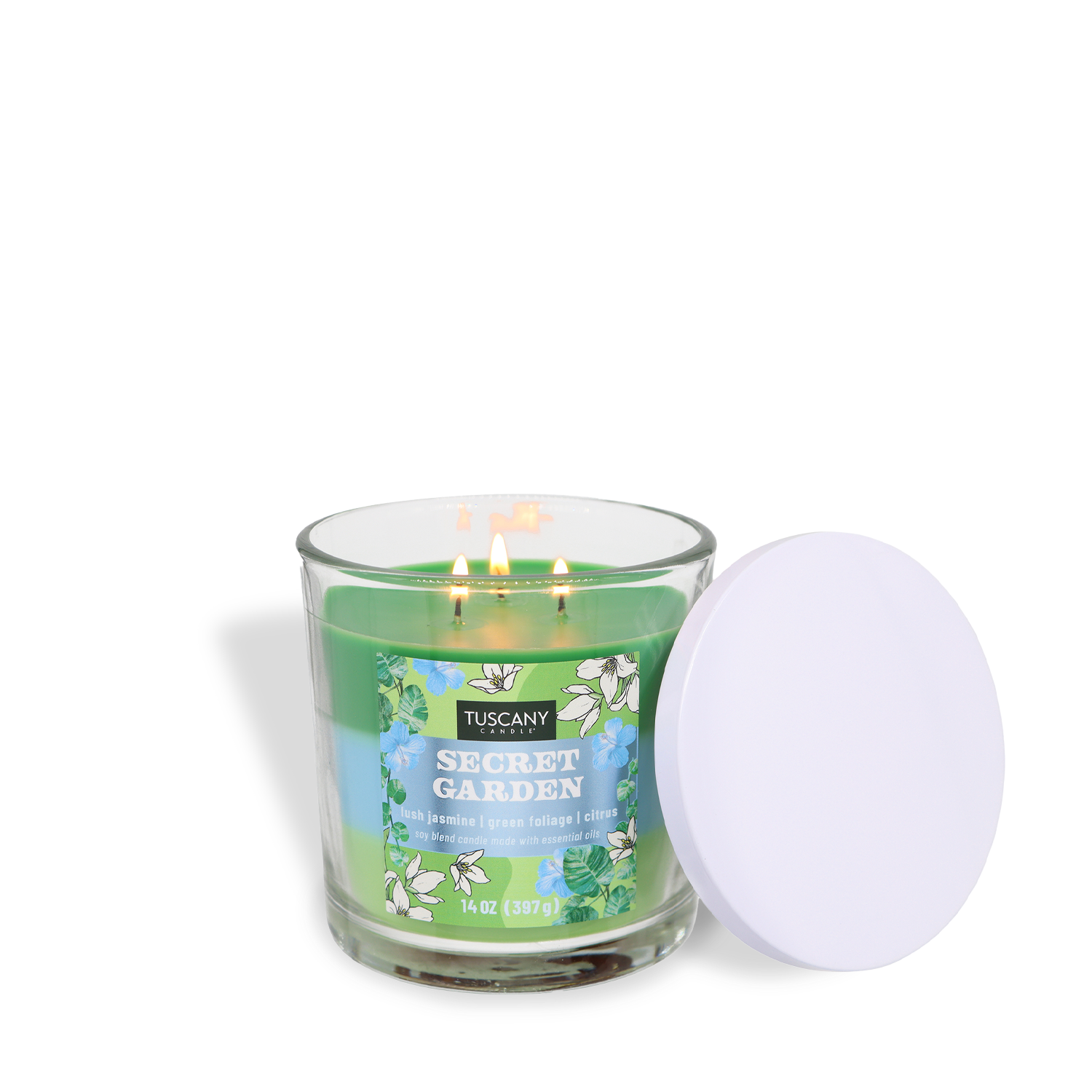 A lit Tuscany Candle® SEASONAL "Secret Garden: Jasmine & Citrus Scented Spring Candle" (14 oz) in a clear glass jar with white flowers on the label sits beside a white lid.