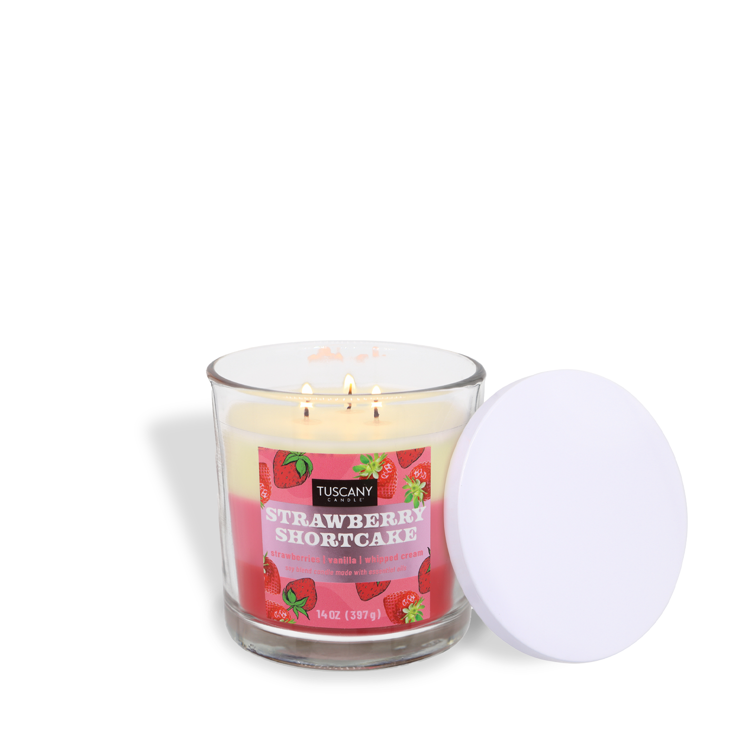 A lit Tuscany Candle® SEASONAL Strawberry Shortcake: Vanilla & Whipped Cream Scented Spring Candle (14 oz) with three wicks, pink label, and white lid fills the air with a sweet spring aroma.