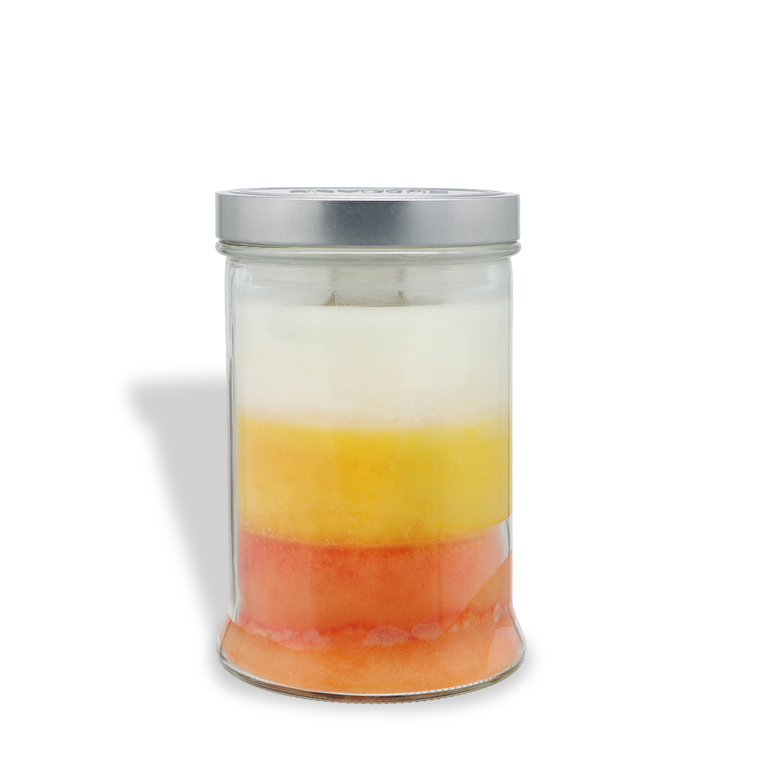 An 18 oz Tuscany Candle® SEASONAL “Candy Corn: Buttery Candy & Vanilla Scented Halloween Candle” in a glass jar features three festive layers—white on top, yellow in the middle, and orange at the bottom—and is finished with a silver lid.