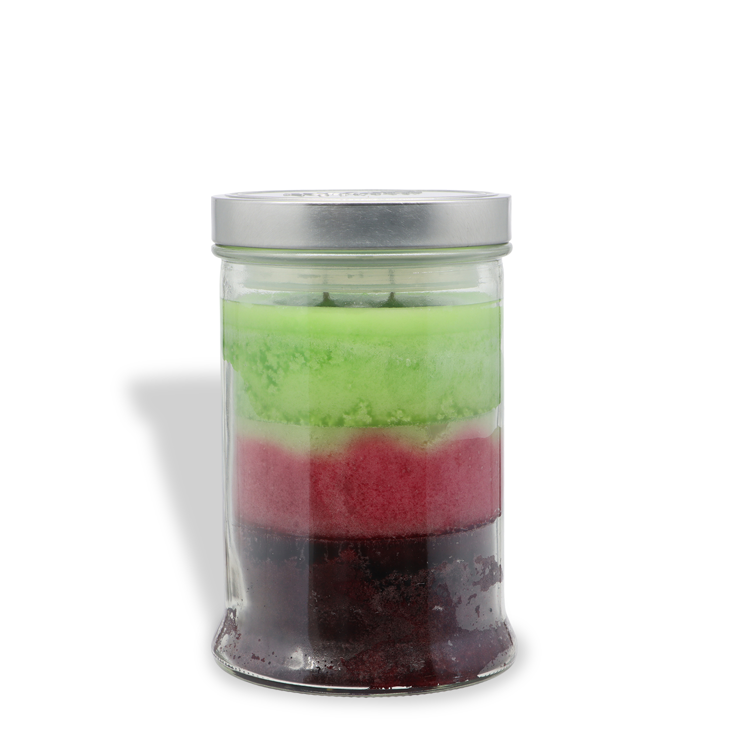 A clear glass jar with a silver lid, containing three colored layers—green on top, red in the middle, and dark purple at the bottom—holds the Tuscany Candle® SEASONAL “Sweet Scream: Berries & Cursed Treats” scented Halloween candle (18 oz). The product is photographed against a white background.