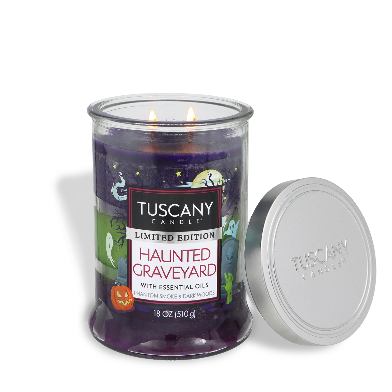 An 18 oz Tuscany Candle® SEASONAL “Haunted Graveyard: Phantom Smoke & Dark Woods” scented Halloween candle, featuring purple wax, Halloween-themed graphics, and a silver lid set beside it.