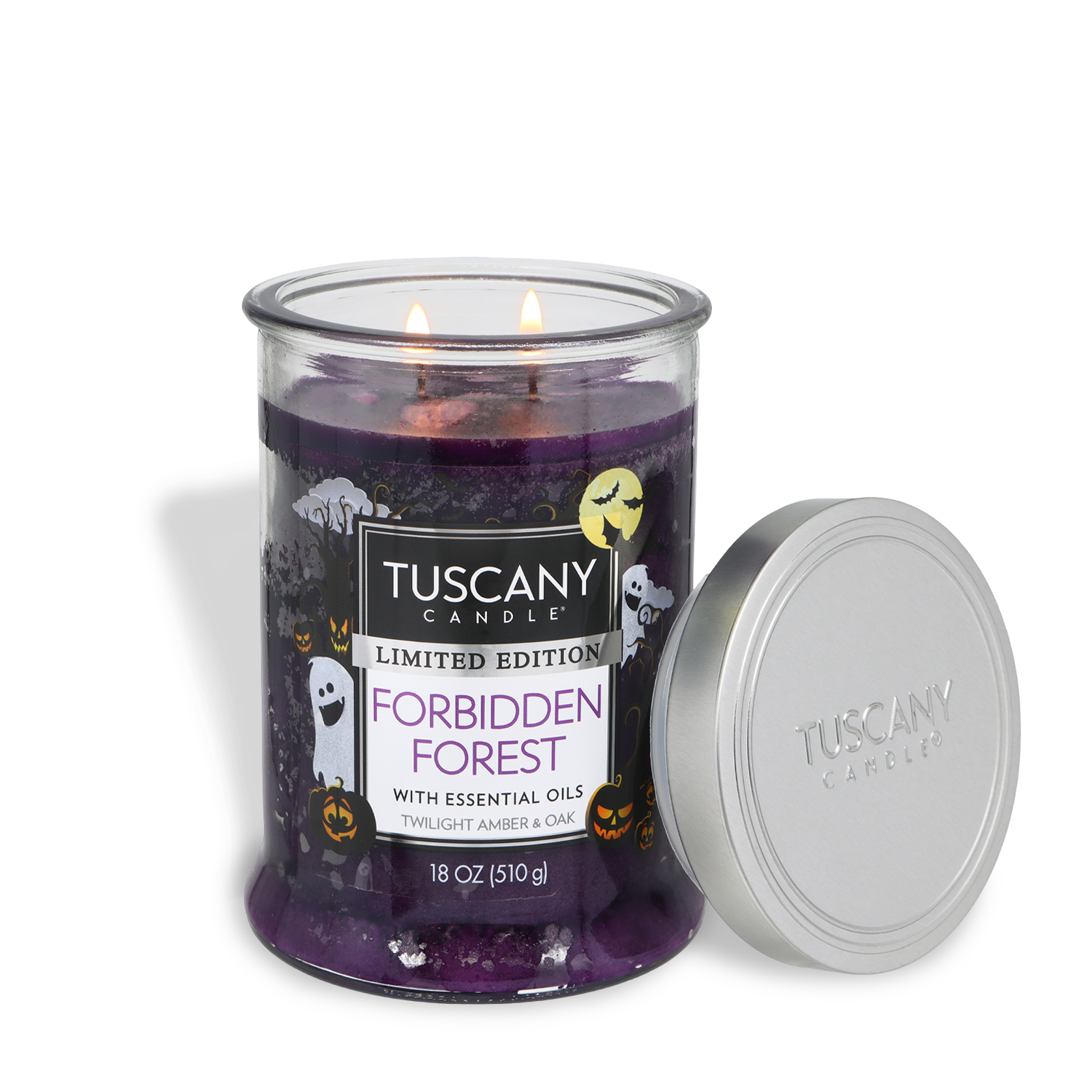 A purple Tuscany Candle® SEASONAL “Forbidden Forest: Twilight Amber & Oak Scented Halloween Candle” (18 oz), adorned with Halloween designs, features two lit wicks and a silver lid resting beside it.