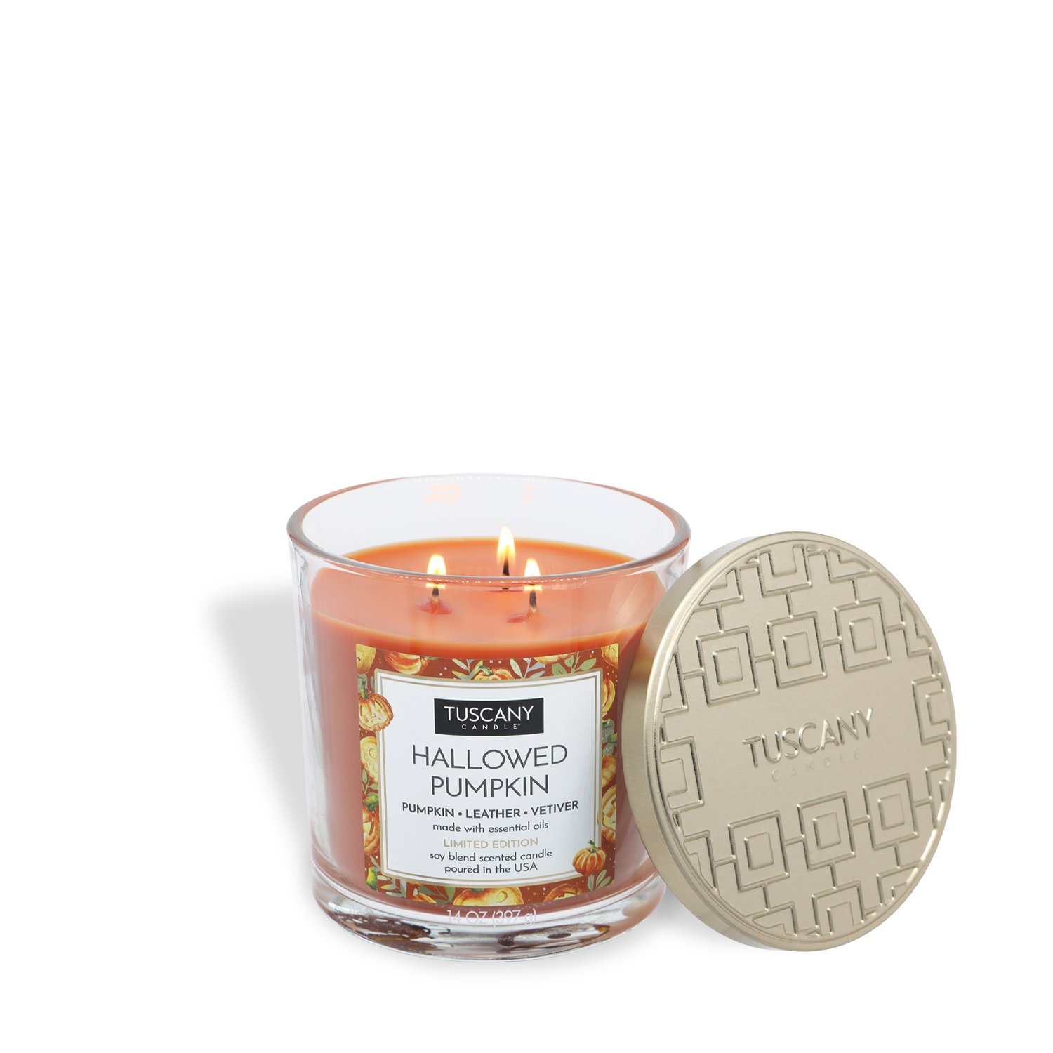 A lit Tuscany Candle® SEASONAL Hallowed Pumpkin: Pumpkin & Leather Scented Halloween Candle (14 oz) in a glass jar, with its metallic lid set beside it.