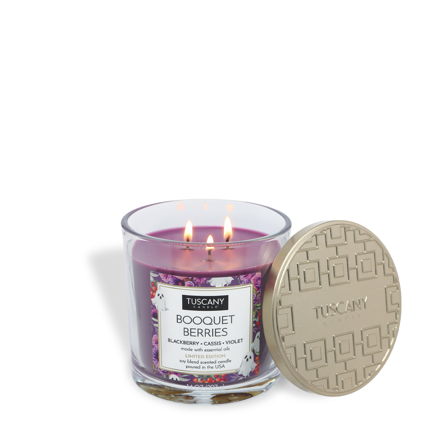A Tuscany Candle® SEASONAL “Booquet Berries: Blackberry & Cassis Scented Halloween Candle” (14 oz) with three lit wicks, purple wax, and a gold lid placed next to the glass jar.