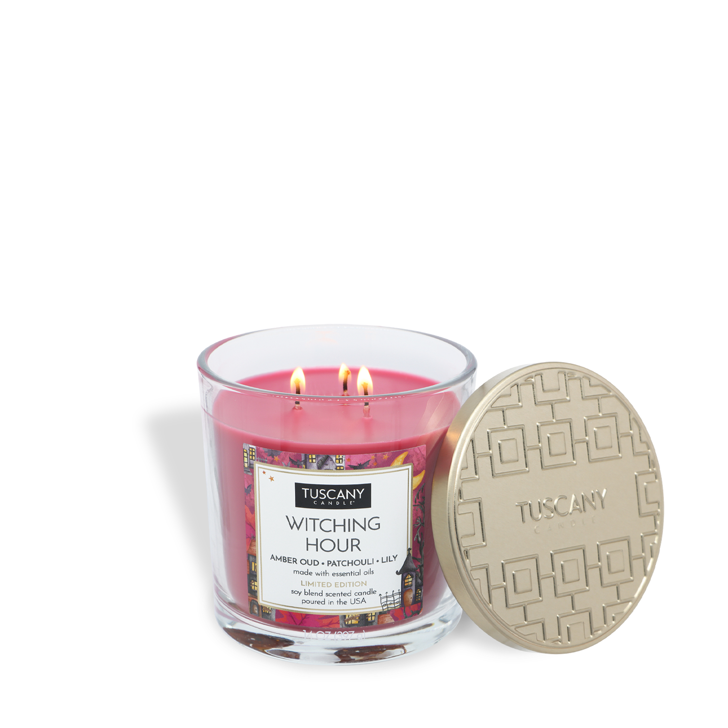 A three-wick “Witching Hour: Patchouli & Oud Scented Halloween Candle” (14 oz) by Tuscany Candle® SEASONAL sits in a clear jar with its gold-embossed lid beside it.