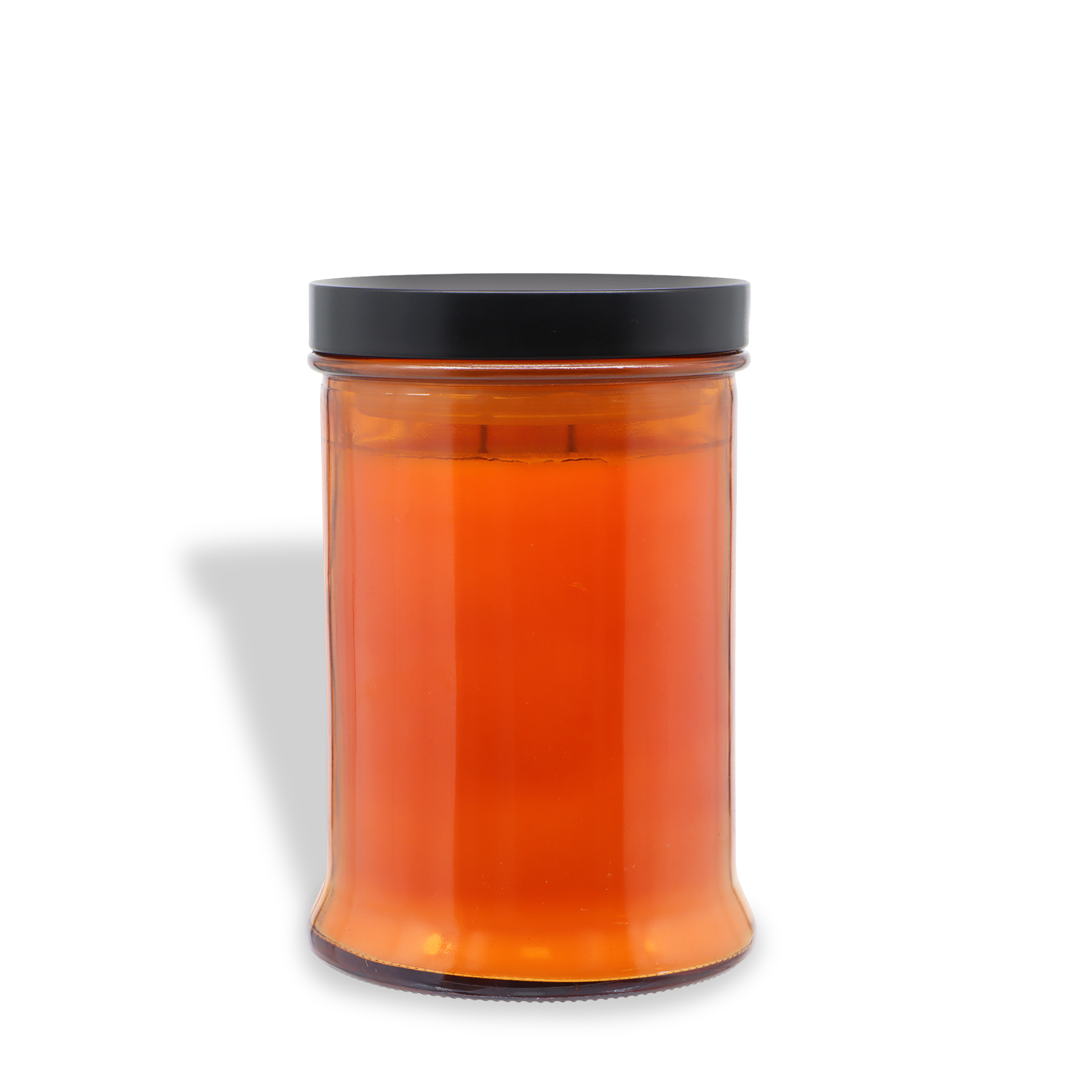 An 18 oz clear glass jar of Tuscany Candle® SEASONAL’s Haunted Patch: Pumpkin, Leather & Ginger Scented Halloween Candle, sealed with a black lid and filled with orange wax, sits on a white background with a visible shadow.