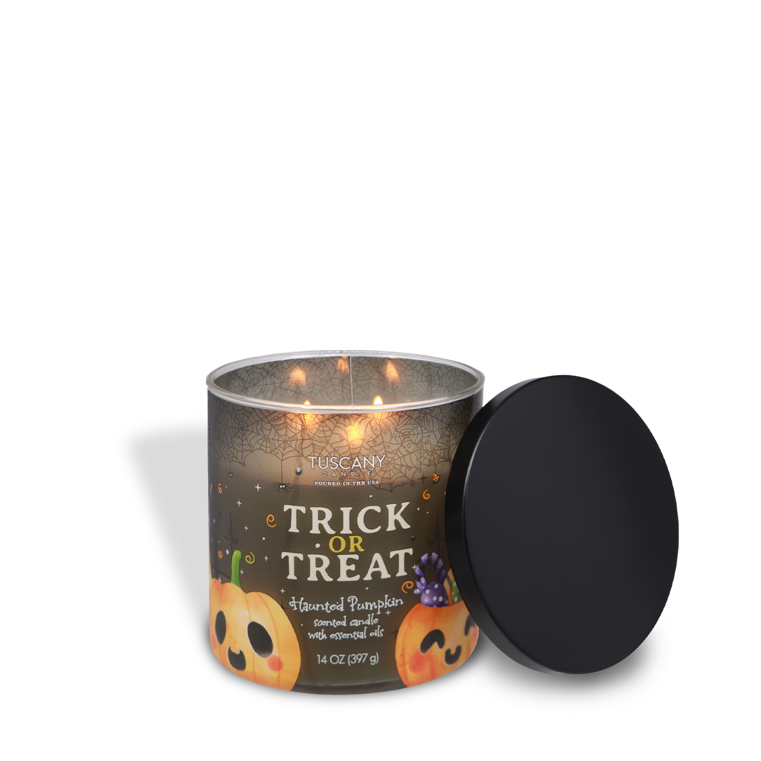 A lit Tuscany Candle® SEASONAL Trick or Treat: Haunted Pumpkin Scented Halloween Candle (14 oz) in a glass jar featuring pumpkin illustrations, with its black lid set open beside it.