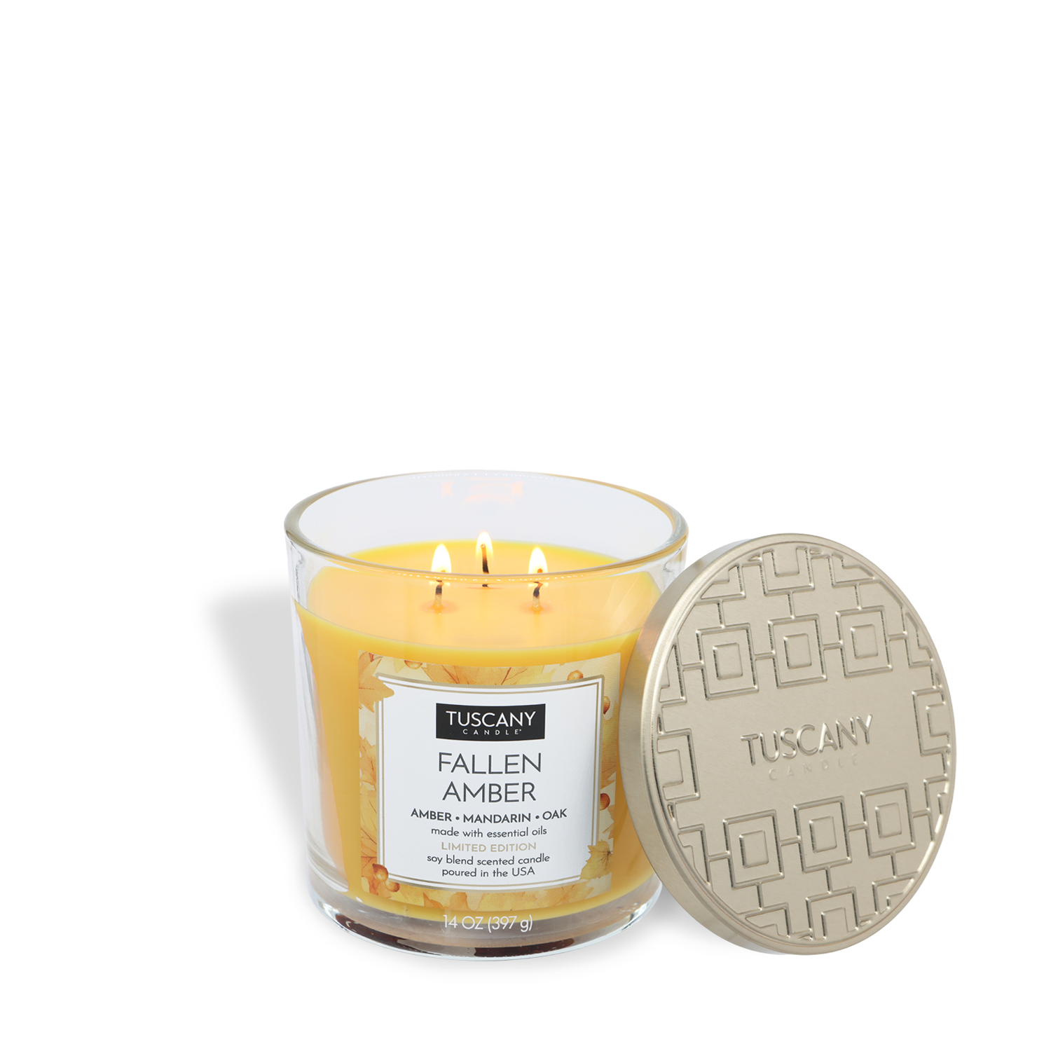 A Tuscany Candle® SEASONAL "Fallen Amber: Mandarin & Oak" 14 oz glass jar candle with three wicks and yellow wax sits beside its textured, round lid.