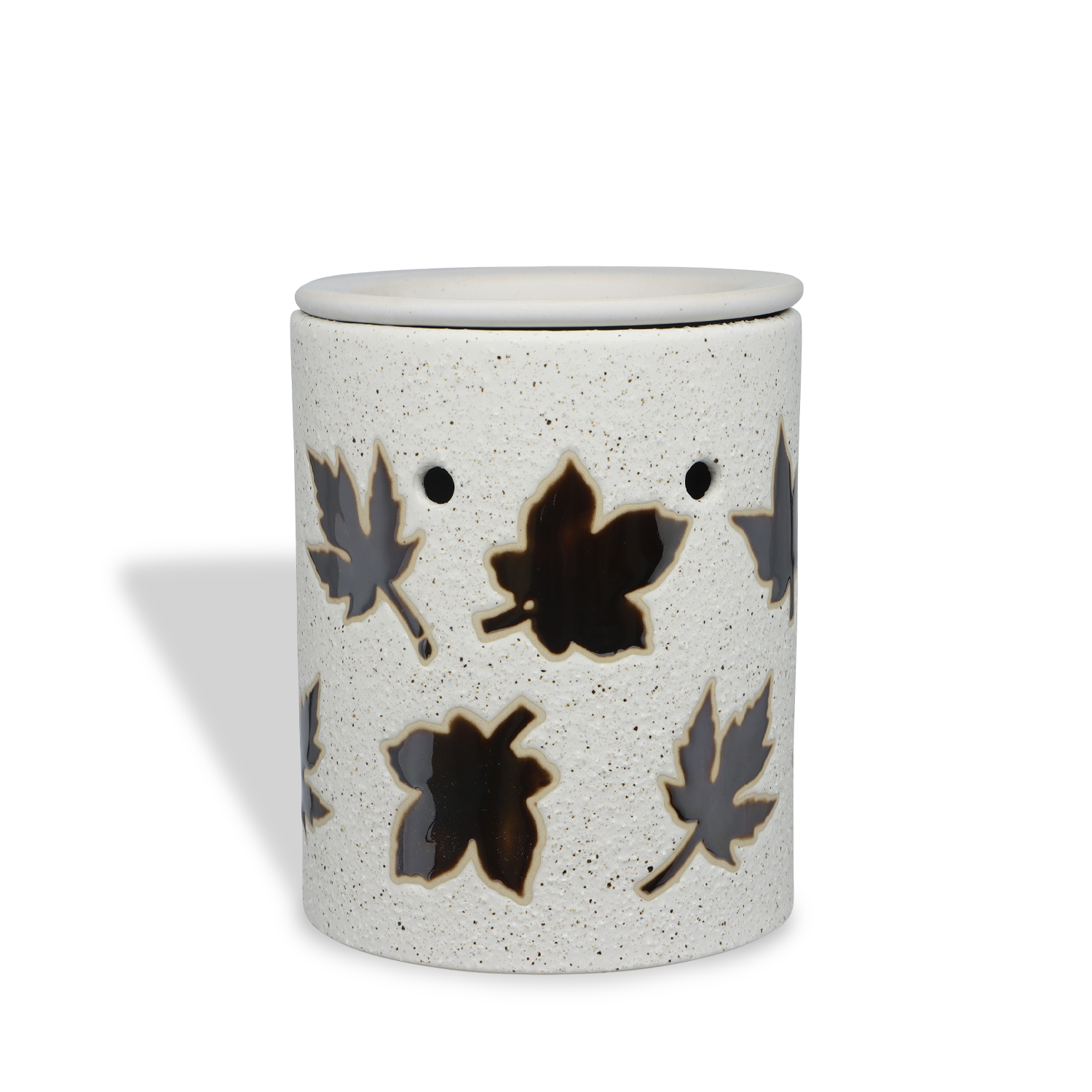 The Tuscany Candle® SEASONAL Autumn Leaf Outlet Wax Melt Warmer is a cylindrical white ceramic warmer with cutout leaf shapes and a speckled finish, ideal for flameless fragrance, shown against a white background.