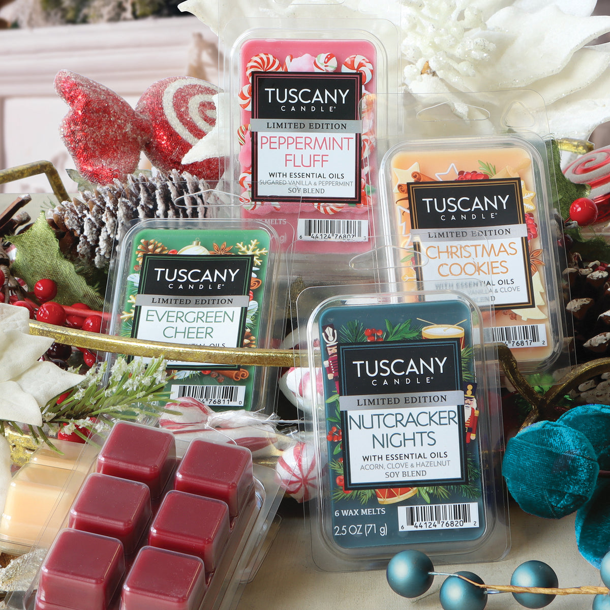Four wax melt packages, including Christmas Cookies: Cinnamon Spice & Vanilla Scented Holiday Wax Melt (2.5 oz), arranged with festive holiday decor labeled Peppermint Fluff, Evergreen Cheer, and Nutcracker Nights.