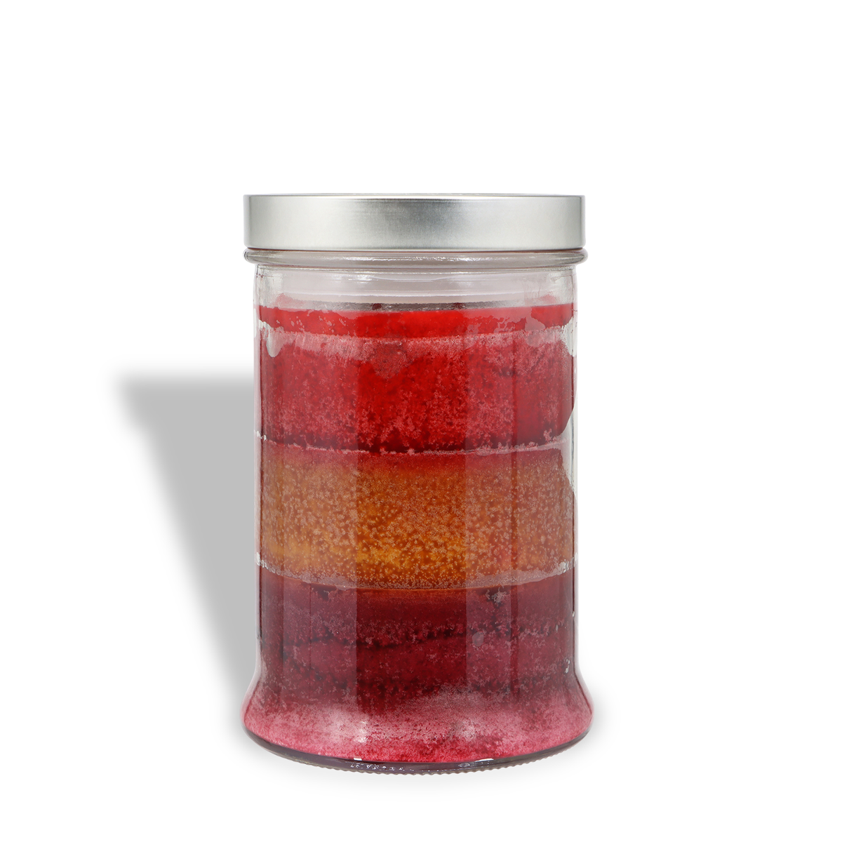 A Bayberry Wishes: Bayberries & Pine Scented Holiday Candle (18 oz) by Tuscany Candle® SEASONAL in a glass jar with a silver lid, featuring three horizontal layers of red, gold, and dark red wax.