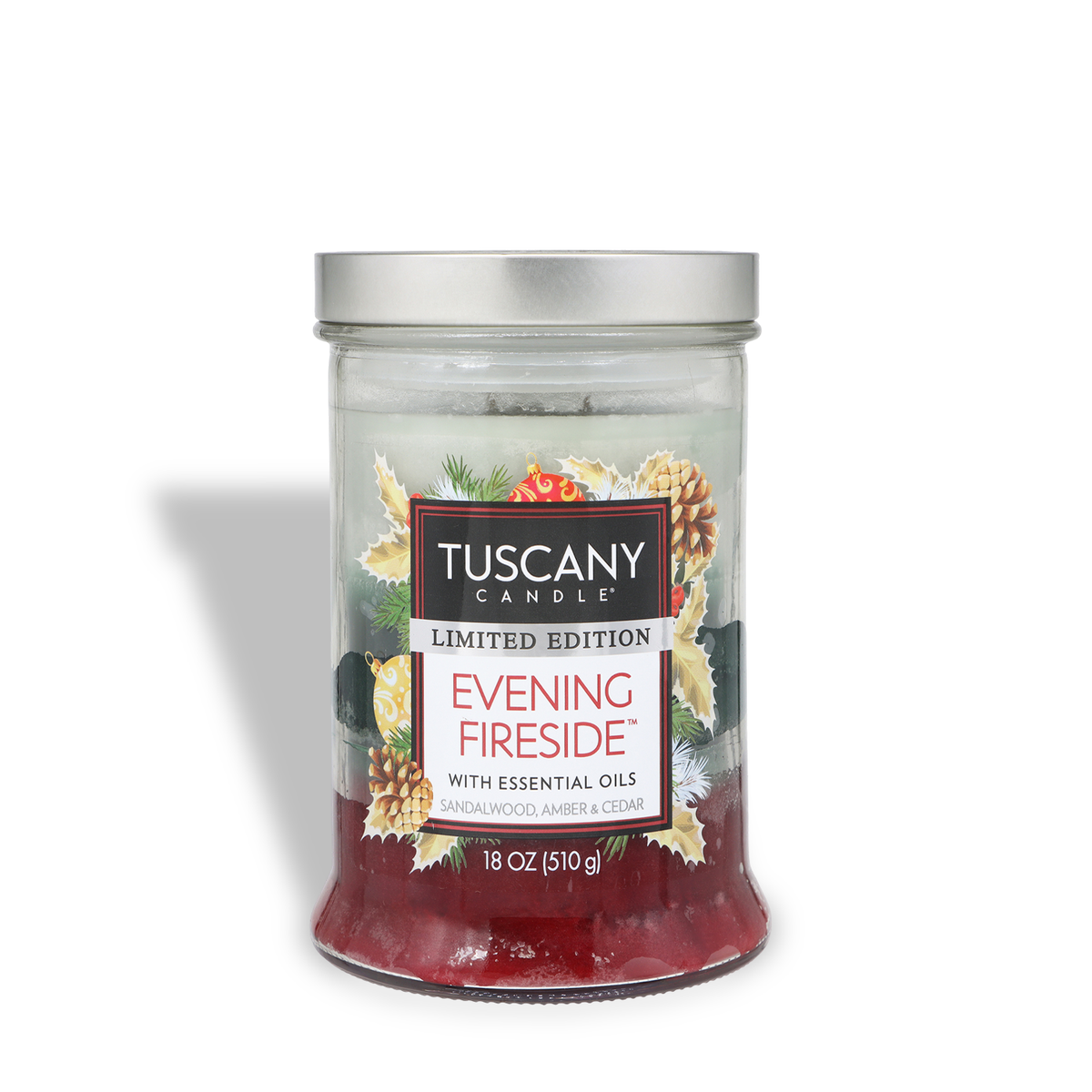 Evening Fireside®: Sandalwood & Amber Scented Holiday Candle (18 oz) in a jar with a silver lid and a label featuring pine, holly, and pinecone illustrations.