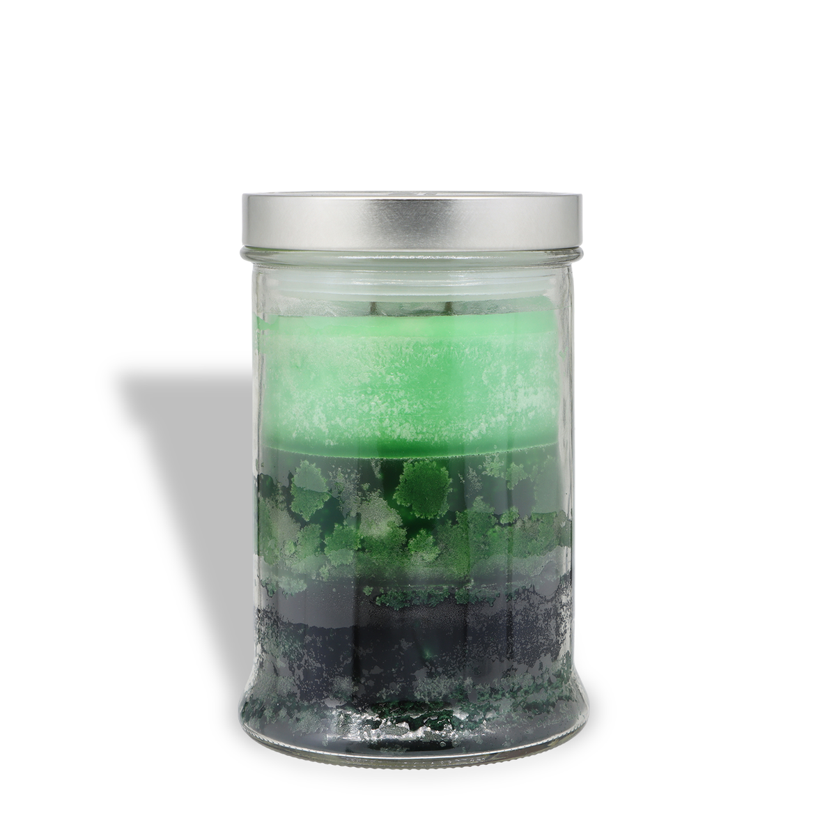 Tuscany Candle® SEASONAL Snowdrift Juniper: Juniper Berry & Fresh Pine Scented Holiday Candle (18 oz) in a glass jar with layers of green and black wax and a silver lid.