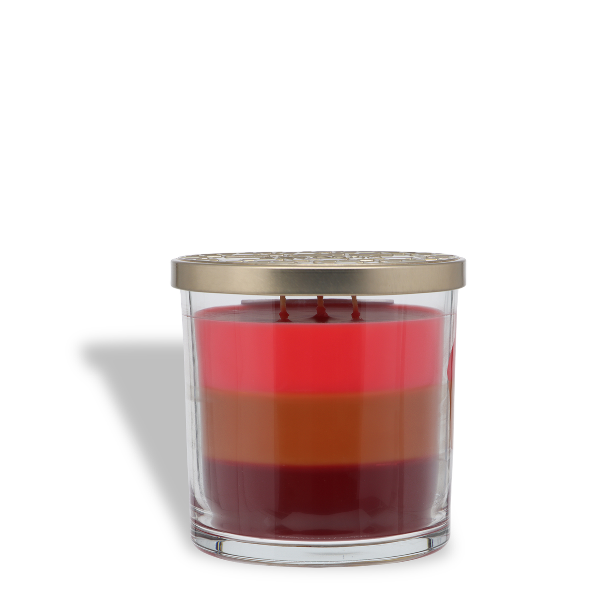 Santa’s Chai: Cinnamon & Clove Scented Holiday Candle (14 oz) in a clear glass jar with three horizontal layers of red, orange, and dark red wax, topped with a decorative metal lid.