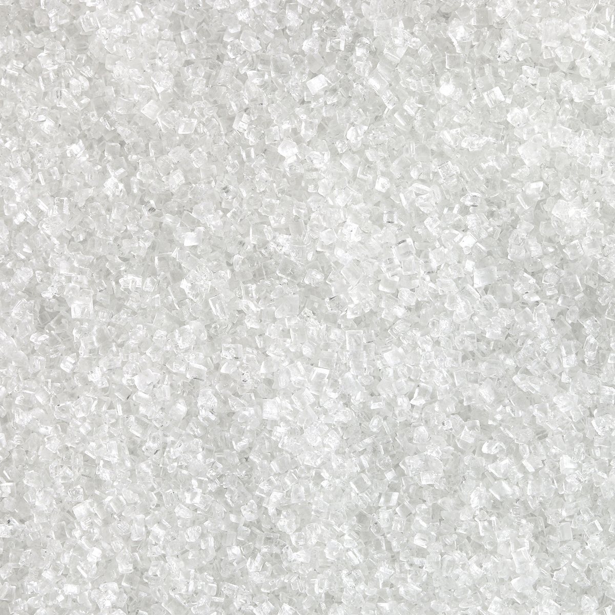 A close-up view of clear, crystalline granules of sugar on a Peppermint Candy Canes: Sugar & Vanilla Scented Holiday Candle (14 oz) by Tuscany Candle® SEASONAL.