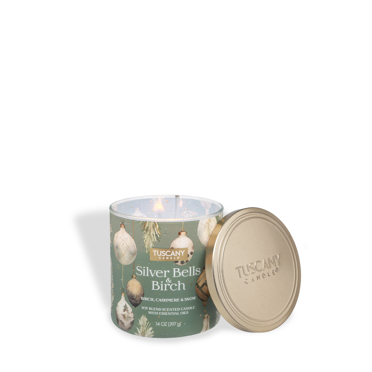 A Silver Bells & Birch: Cashmere & Snow Scented Holiday Candle (14 oz) in a green jar decorated with Christmas ornaments, with its gold lid resting beside it.