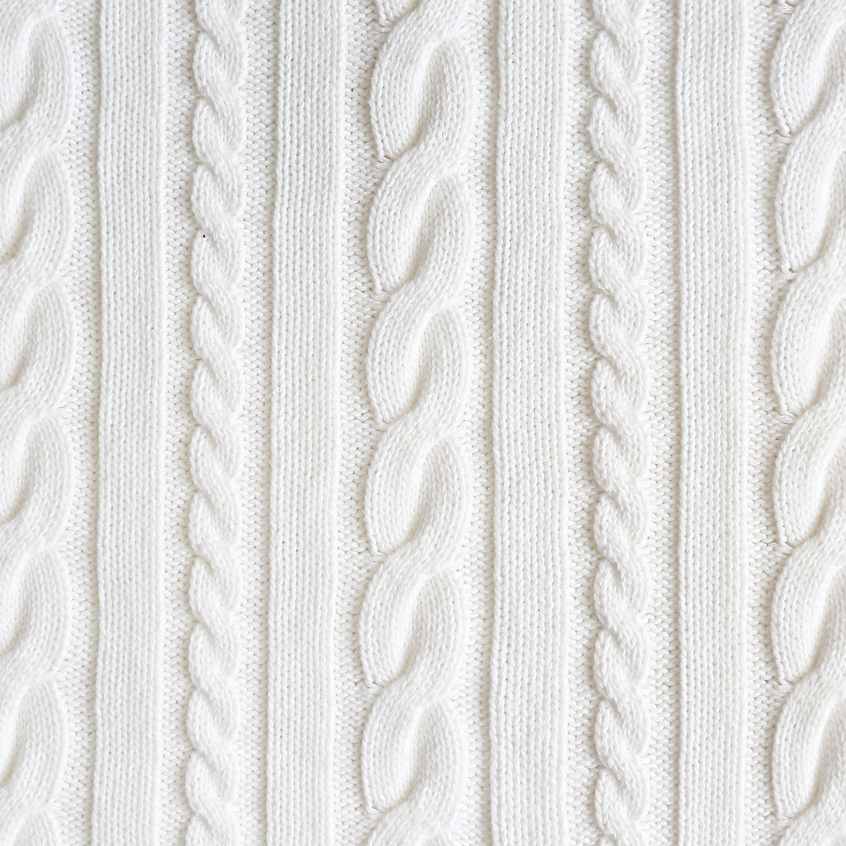 White knitted fabric with a vertical cable-knit pattern accompanying a Silver Bells & Birch: Cashmere & Snow Scented Holiday Candle (14 oz) by Tuscany Candle® SEASONAL.