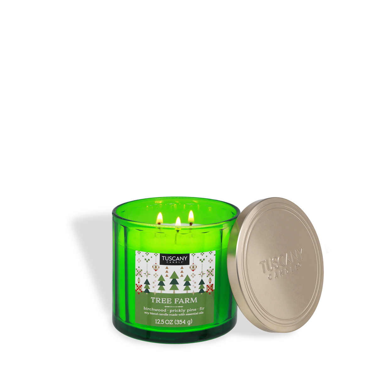 A three-wick Tuscany Candle® SEASONAL Tree Farm: Warm Birchwood & Pine Scented Holiday Candle (12.5 oz) in a green glass jar with the lid off, featuring a label with pine tree graphics.