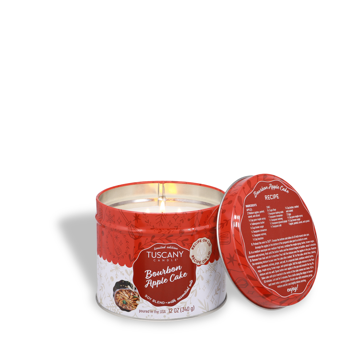 A red tin Bourbon Apple Cake Scented Holiday Candle (12 oz) with the lid off, showing a recipe printed on the inside of the lid.
