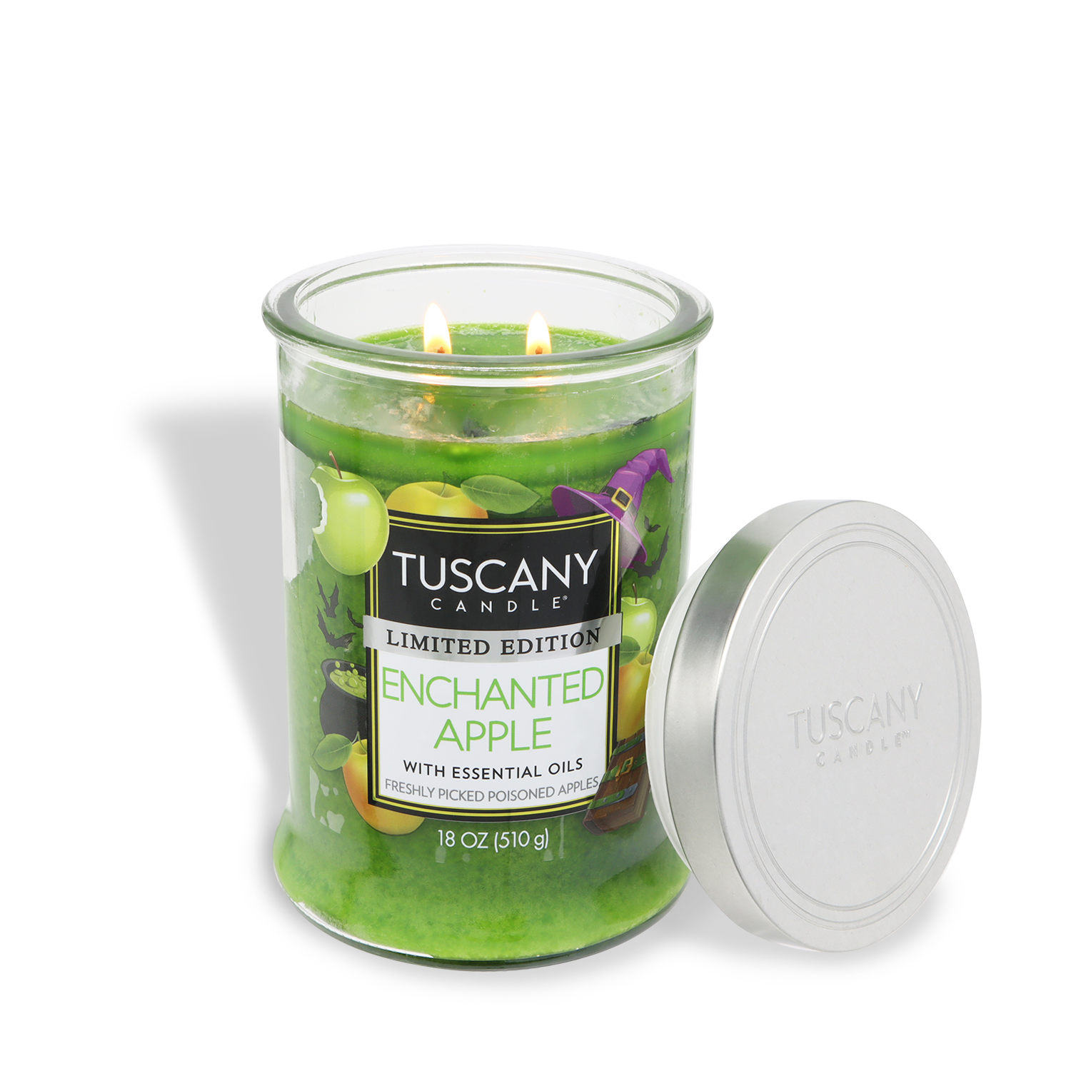 A green Tuscany Candle® SEASONAL "Enchanted Apple: Caramel & Poisoned Apple" 18 oz Halloween candle with two lit wicks sits by its silver lid on a white background, creating a cozy autumn ambiance with its festive fragrance.