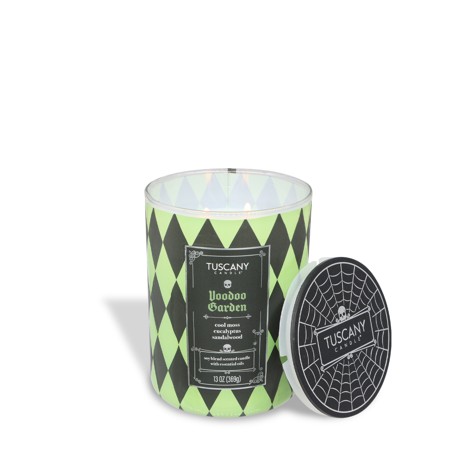 A green and black Tuscany Candle® SEASONAL "Voodoo Garden: Moonflower & Haunting Sage" (13 oz) from the Gothic Spell Collection, spiderweb lid beside it—a perfect Halloween scented candle.
