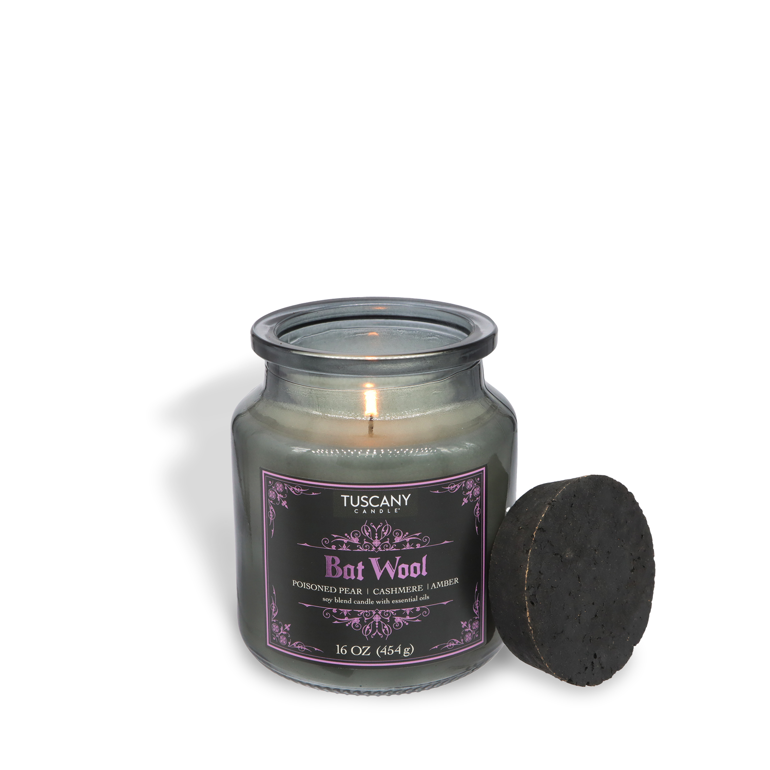 A lit Tuscany Candle® SEASONAL Bat Wool: Poisoned Pear & Candied Rhubarb Scented Halloween Candle (16 oz, Apothecary Collection) glows in a jar with a round black lid beside it on a white background.