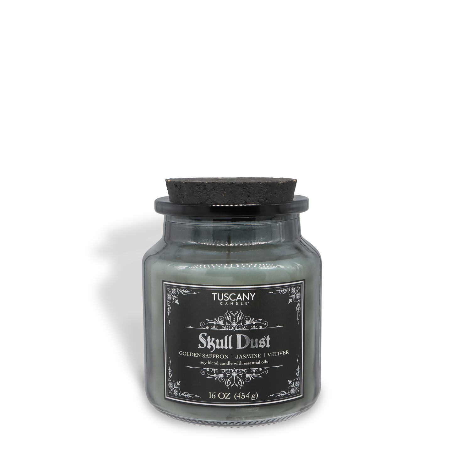The Tuscany Candle® SEASONAL "Skull Dust" Halloween Candle (16 oz) from the Apothecary Collection features Fireside Vanilla & Smooth Vetiver scents in a glass jar with a black lid.