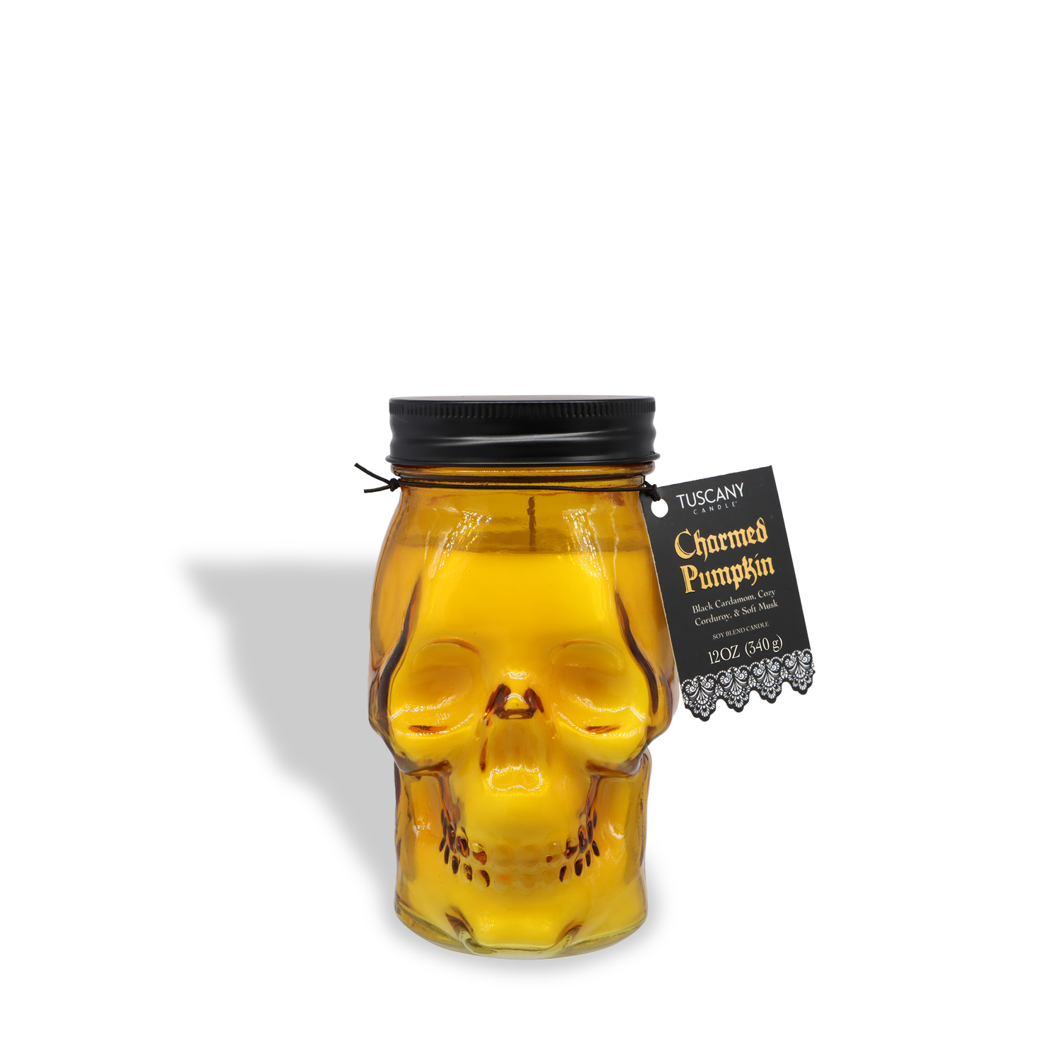 A spooky skull-shaped glass jar candle from Tuscany Candle® SEASONAL, "Charmed Pumpkin: Black Cardamom & Pumpkin Scented" (12 oz), is perfect for Halloween or autumn décor.