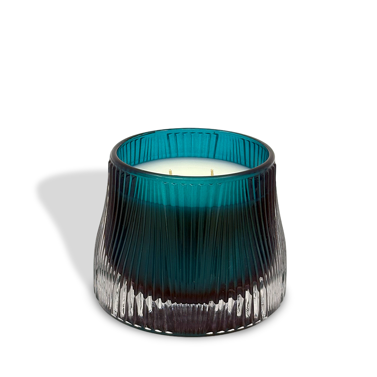 The est.1951 Midnight Iris & Verbena (9oz) features a blue and clear ribbed glass holder with a white, clean-burning three-wick candle casting a shadow on a white background.