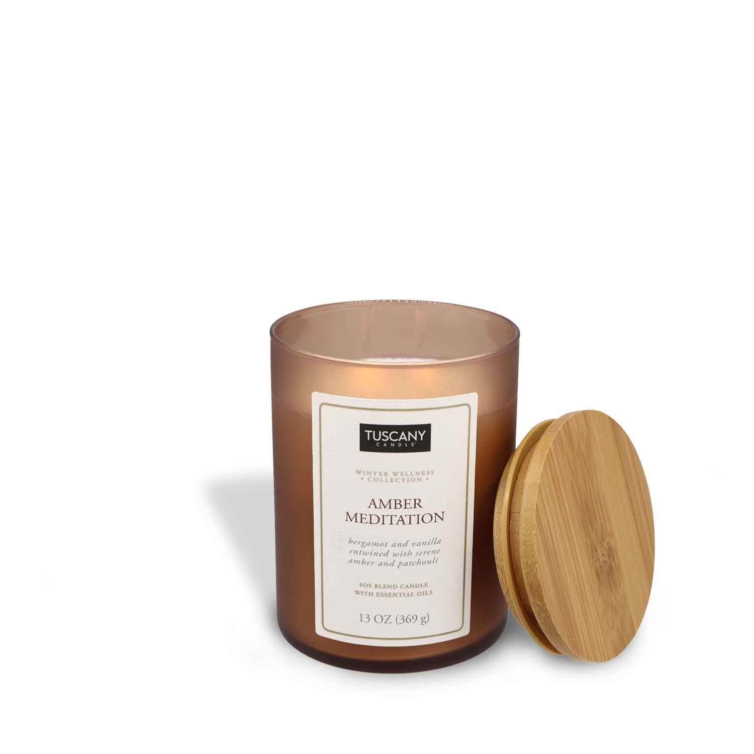 A Tuscany Candle Amber Meditation Scented Jar Candle (13 oz) – Winter Wellness Collection with a wooden lid on a white background.