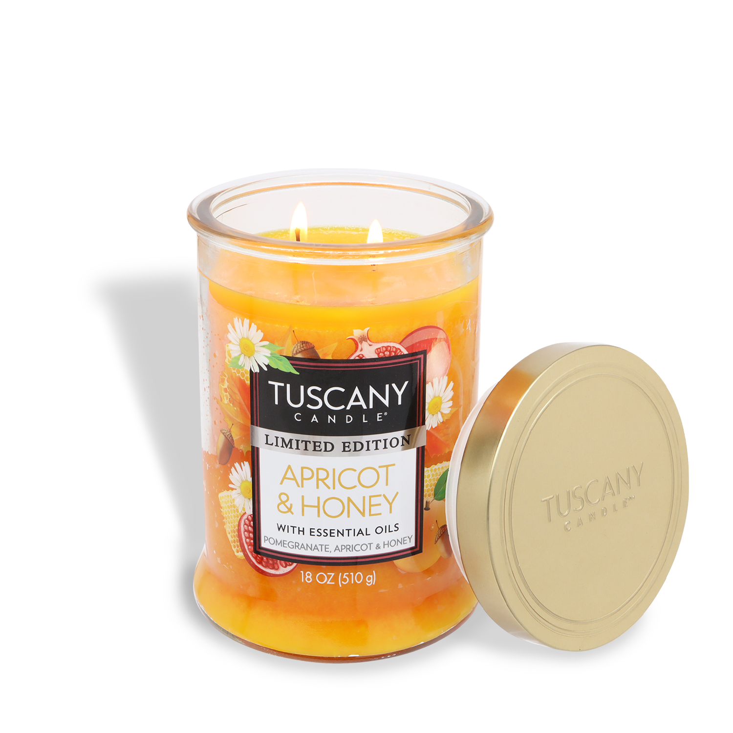An 18 oz Tuscany Candle® SEASONAL Apricot & Honey: Pomegranate & Patchouli scented candle with two wicks in a glass jar, gold lid beside it, and a fruit-themed label on front.
