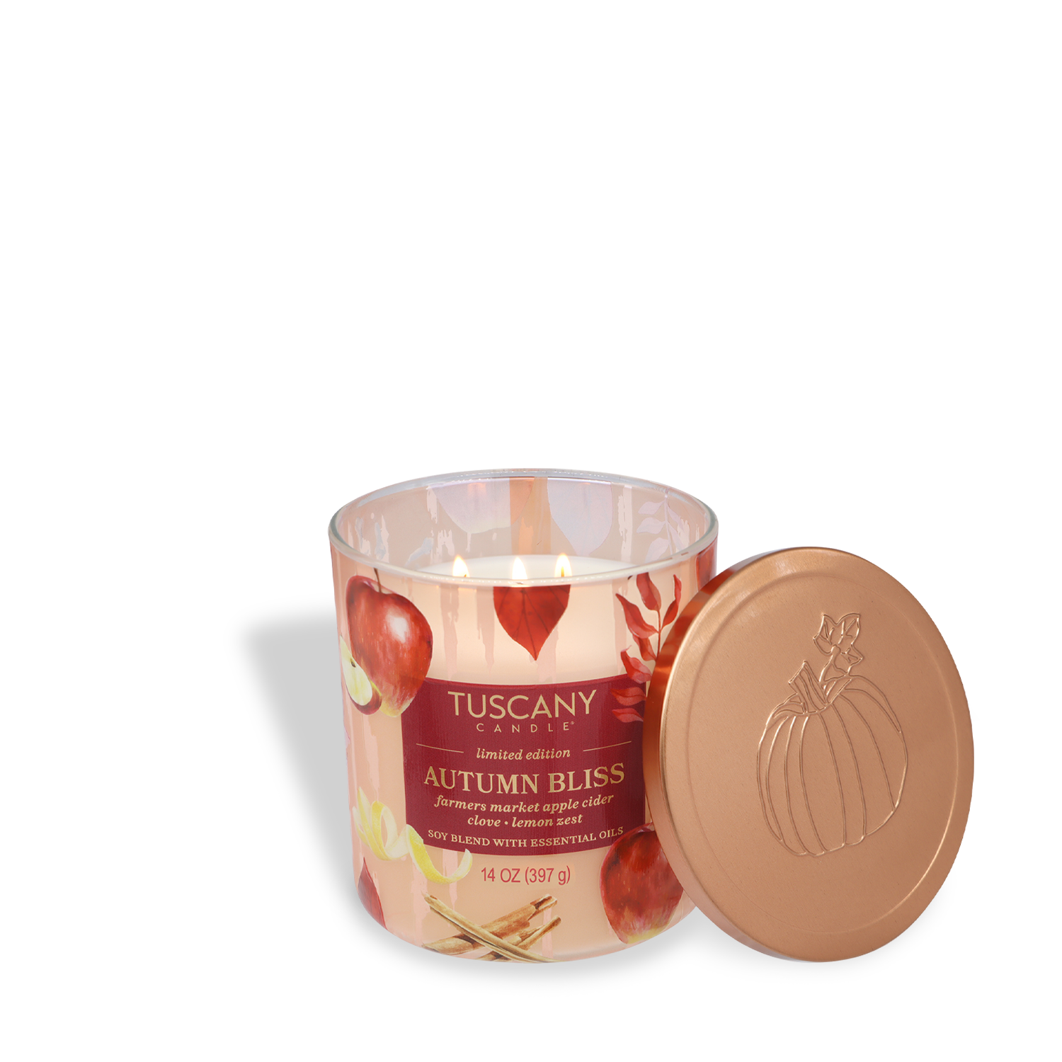 A lit Tuscany Candle® SEASONAL "Autumn Bliss: Apple Cider & Clove" (14 oz) from the Simply Fall Collection sits next to its copper lid, which features a pumpkin design and apple-themed imagery.