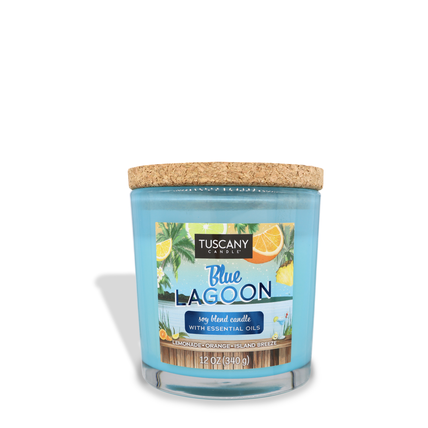 A Tuscany Candle® SEASONAL Blue Lagoon (12 oz) – Sunset Beach Bar Collection soy blend candle with a cork lid. The label features images of palm leaves, sparkling orange slices, and a coastal scene. The candle weighs 12 oz (340 g).