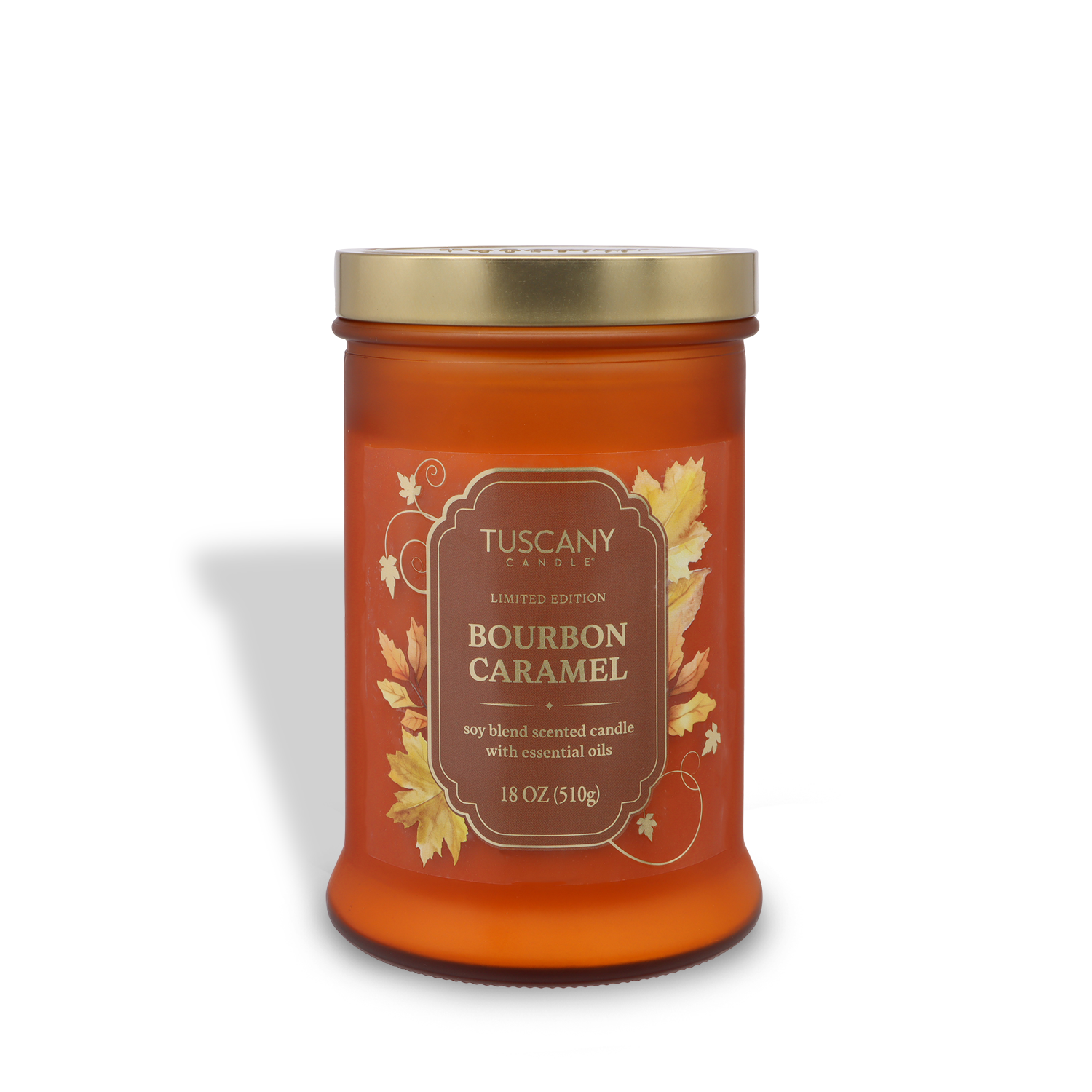 An 18 oz Tuscany Candle® SEASONAL "Bourbon Caramel: Cinnamon & Maple Sugar Scented Fall Candle" in a glass jar with gold lid and autumn leaf design, made from a soy blend with essential oils.