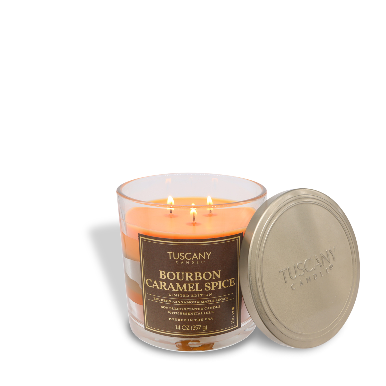 A lit Tuscany Candle® SEASONAL “Bourbon Caramel Spice: Aged Bourbon & Vanilla Scented Fall Candle (14 oz)” in a glass jar with a gold lid beside it.