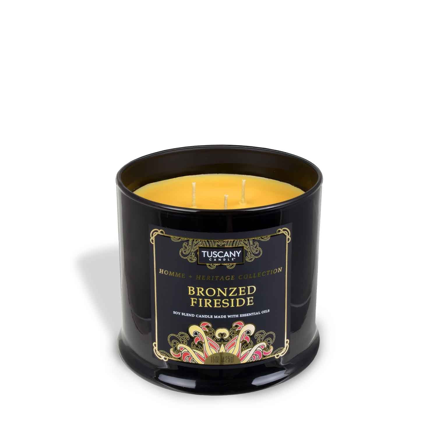 A long-lasting Bronzed Fireside scented jar candle (15 oz) from the Homme + Heritage Collection by Tuscany Candle, in a black tin on a white background.