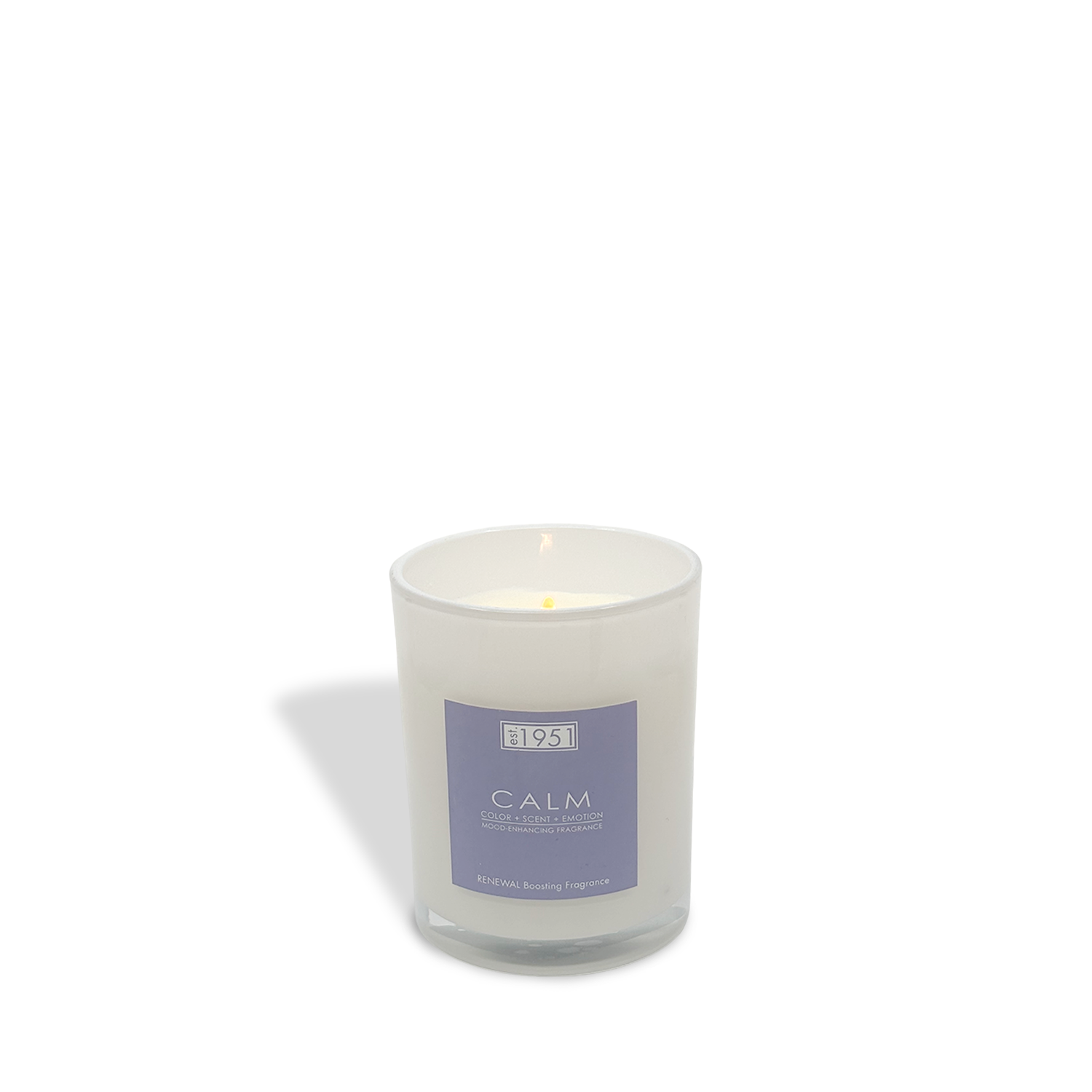 The est.1951 Calm (8oz) white glass candle features a lit wick against a plain white backdrop, filling your space with soothing coconut jasmine and floral aromas.