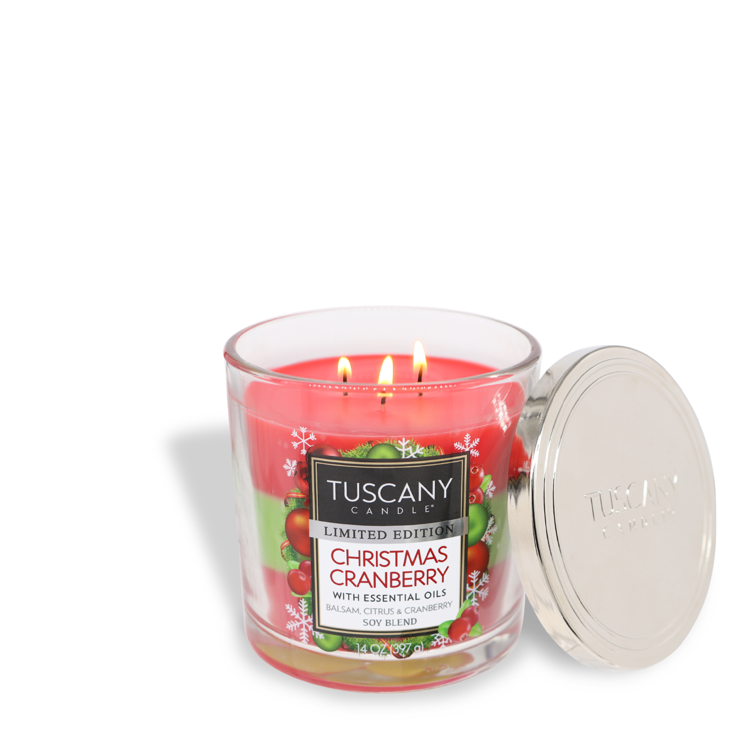 A lit Tuscany Candle® SEASONAL Christmas Cranberry Long-Lasting Scented Jar Candle (14 oz) in a glass jar with a metal lid placed beside it. The candle has three wicks and features holiday-themed packaging.