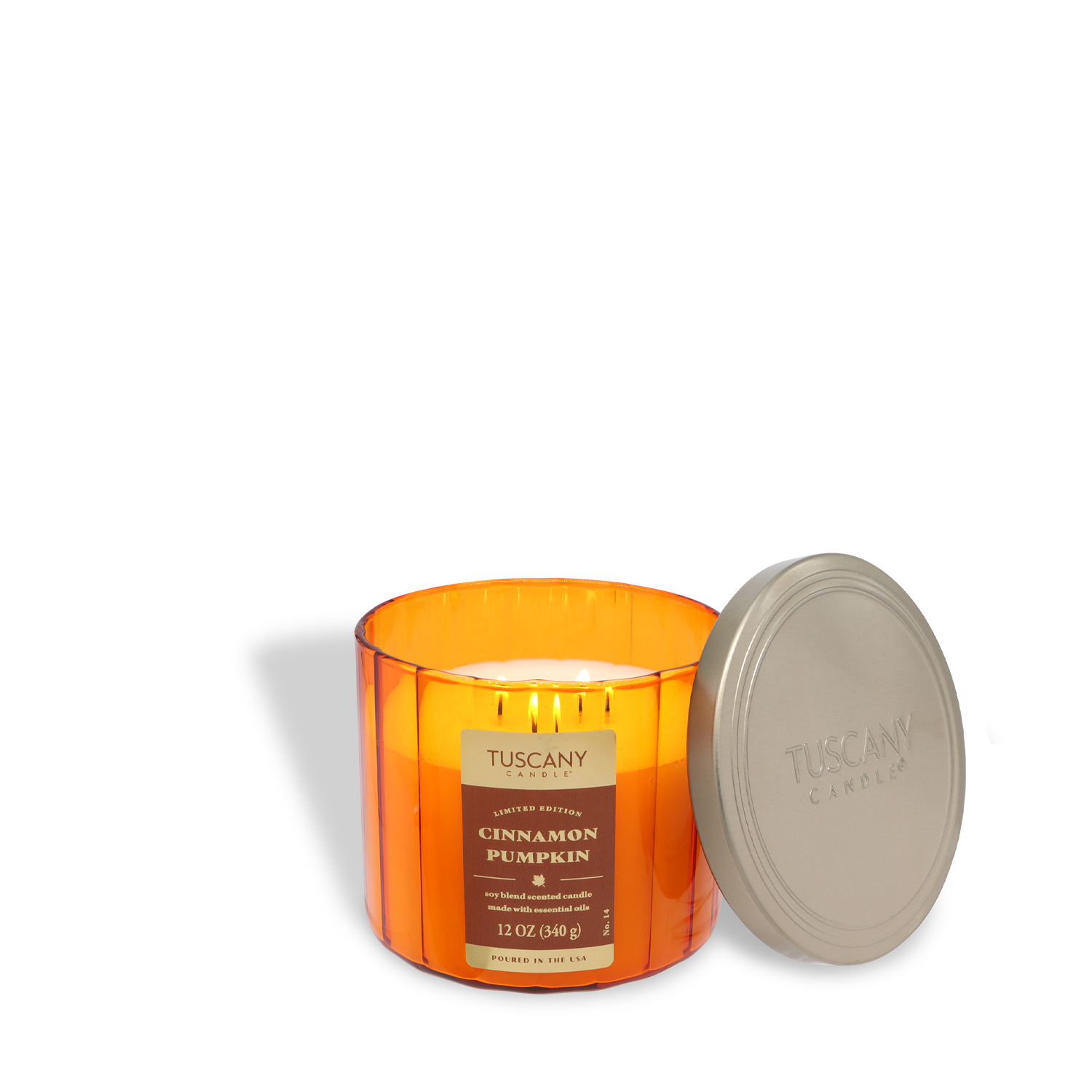 A 12 oz Tuscany Candle® SEASONAL "Cinnamon Pumpkin: Nutmeg & Pumpkin Scented Fall Candle" with a silver lid sits unused beside it, featuring an orange wax and white wick.