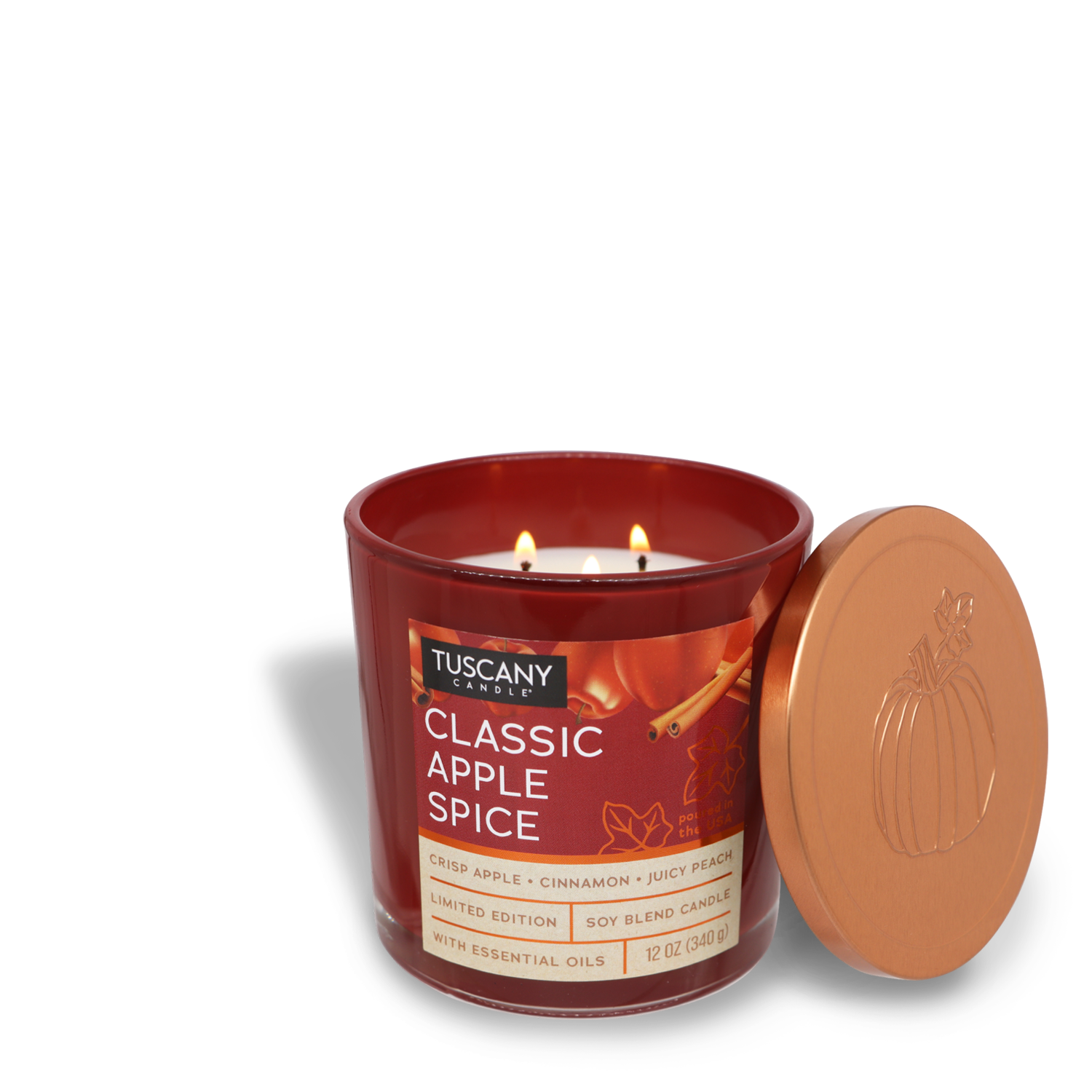 A Tuscany Candle® SEASONAL labeled "Classic Apple Spice Long-Lasting Scented Jar Candle (12 oz)" from the Copper Harvest Collection, with scents of crisp apple, cinnamon, and juicy peach, is open with the lid beside it. The candle has two lit wicks and a pumpkin engraving on the lid. This Autumn fragrance fills the room with cozy warmth.