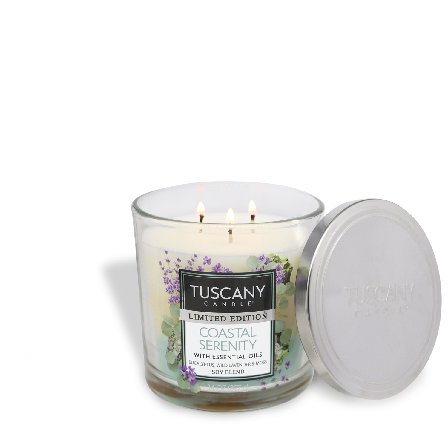 A 14 oz Tuscany Candle® SEASONAL glass jar candle labeled "Coastal Serenity: Eucalyptus Scented Spring Candle" with a metal lid, featuring three wicks and lavender and eucalyptus designs.