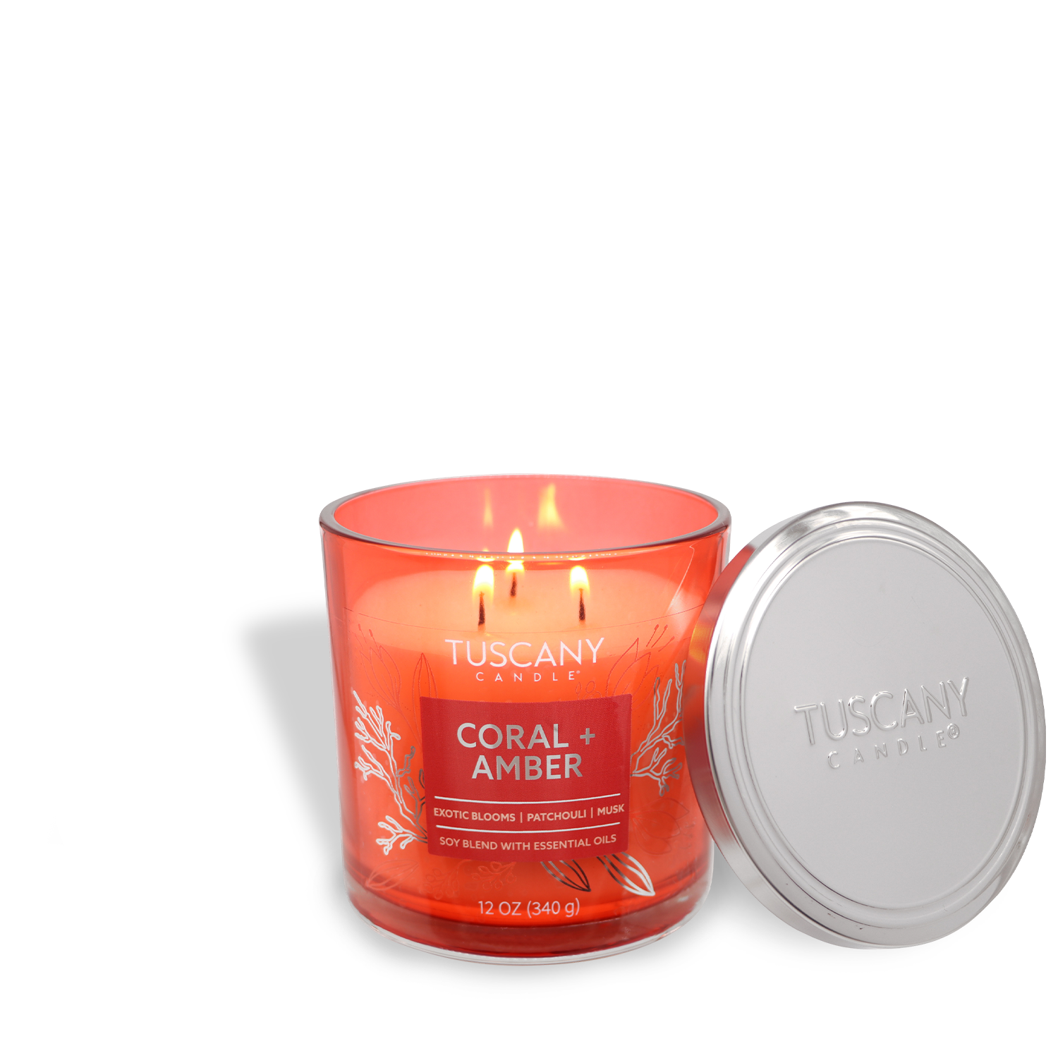 A Tuscany Candle® EVD from the Painters' Palette Collection, labeled "Coral + Amber: Palo Santo Scented Jar Candle" (12 oz), is lit in a glass jar with the lid next to it.