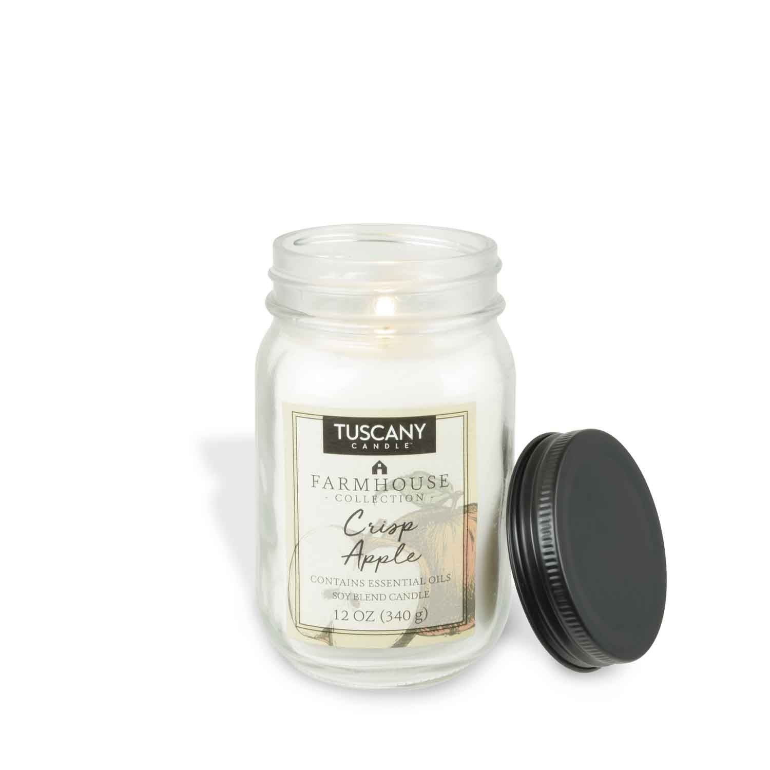 A Crisp Apple Scented Jar Candle (12 oz) – Farmhouse Collection by Tuscany Candle® EVD with a black lid next to it.