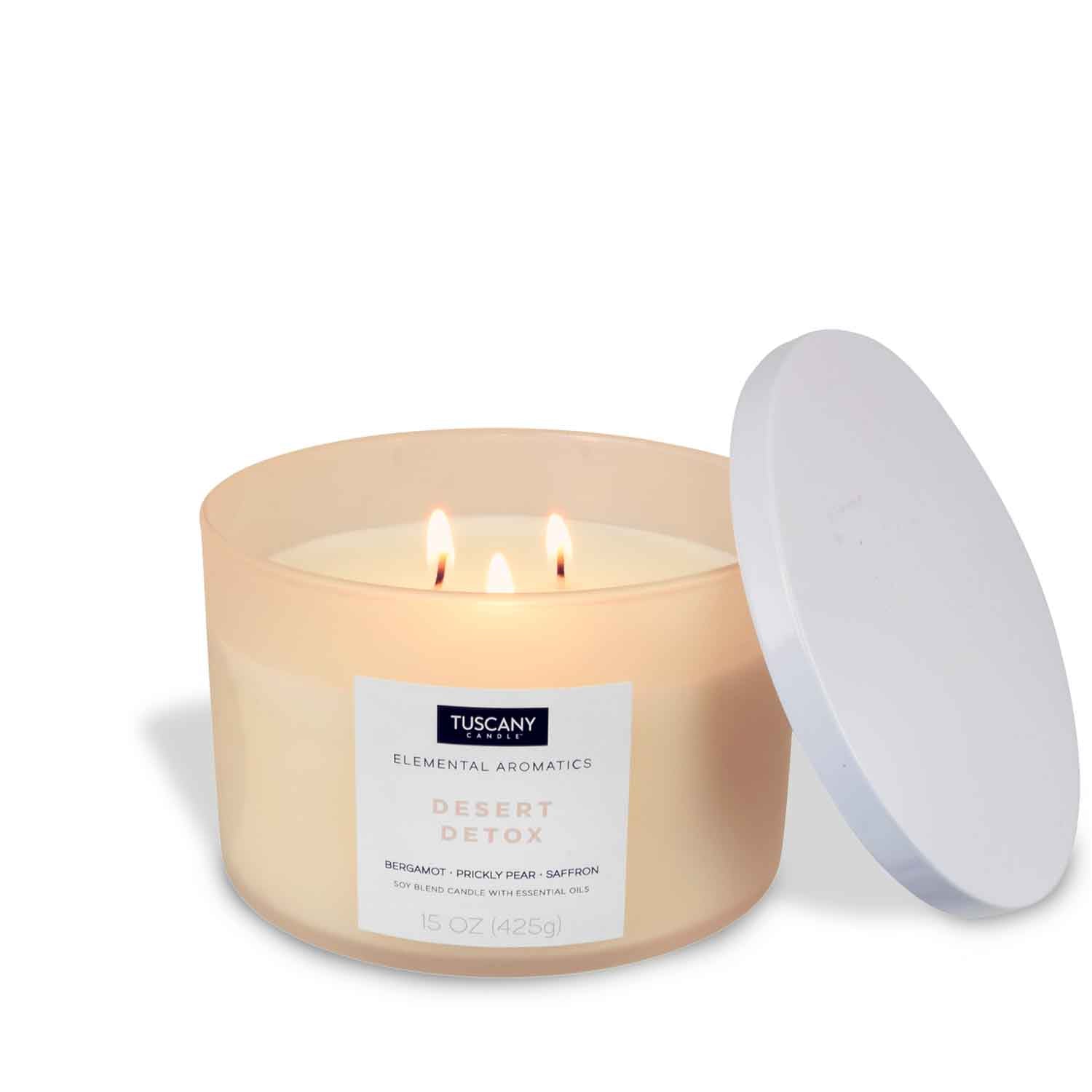 An invigorating Desert Detox scented filled candle from Tuscany Candle with a white lid on a white surface.