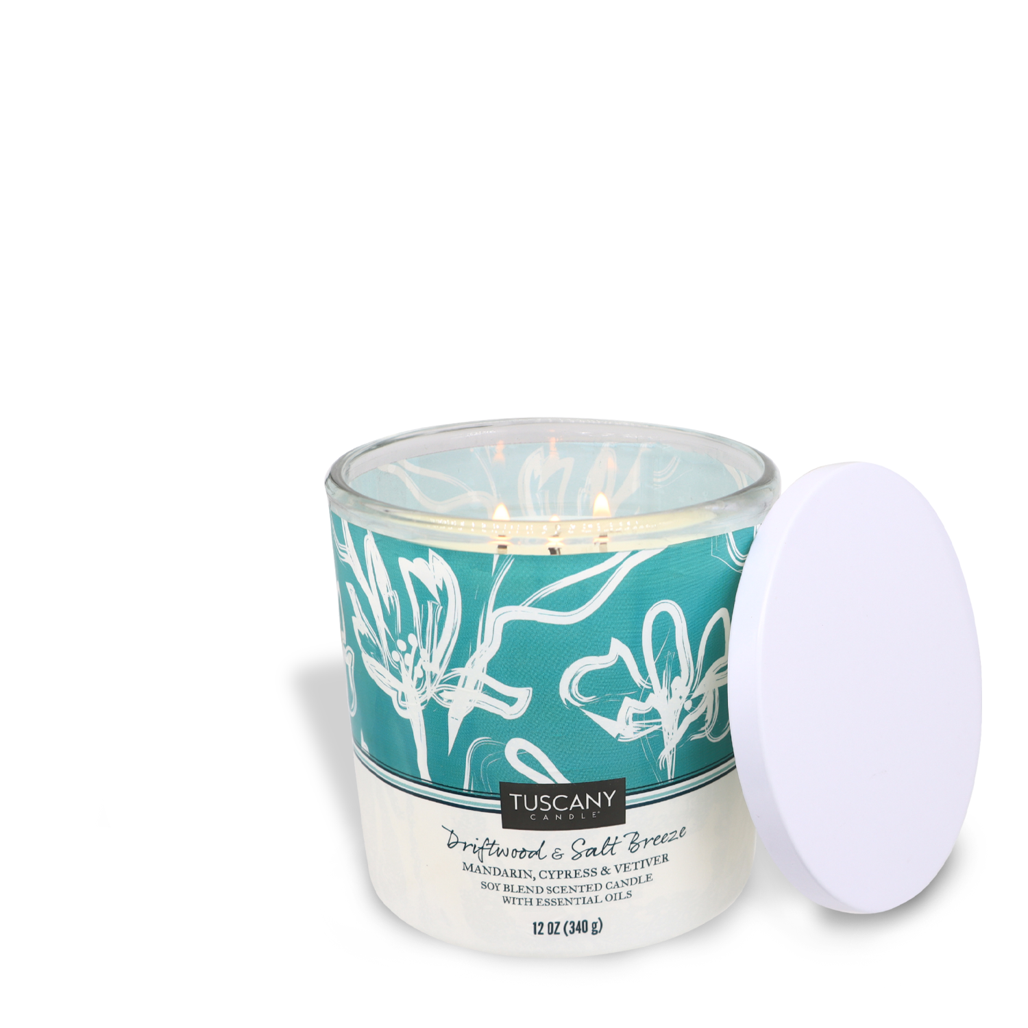 Tuscany Candle® SEASONAL Driftwood & Salt Breeze scented candle with a turquoise and white label, displayed with its white lid off to the side.