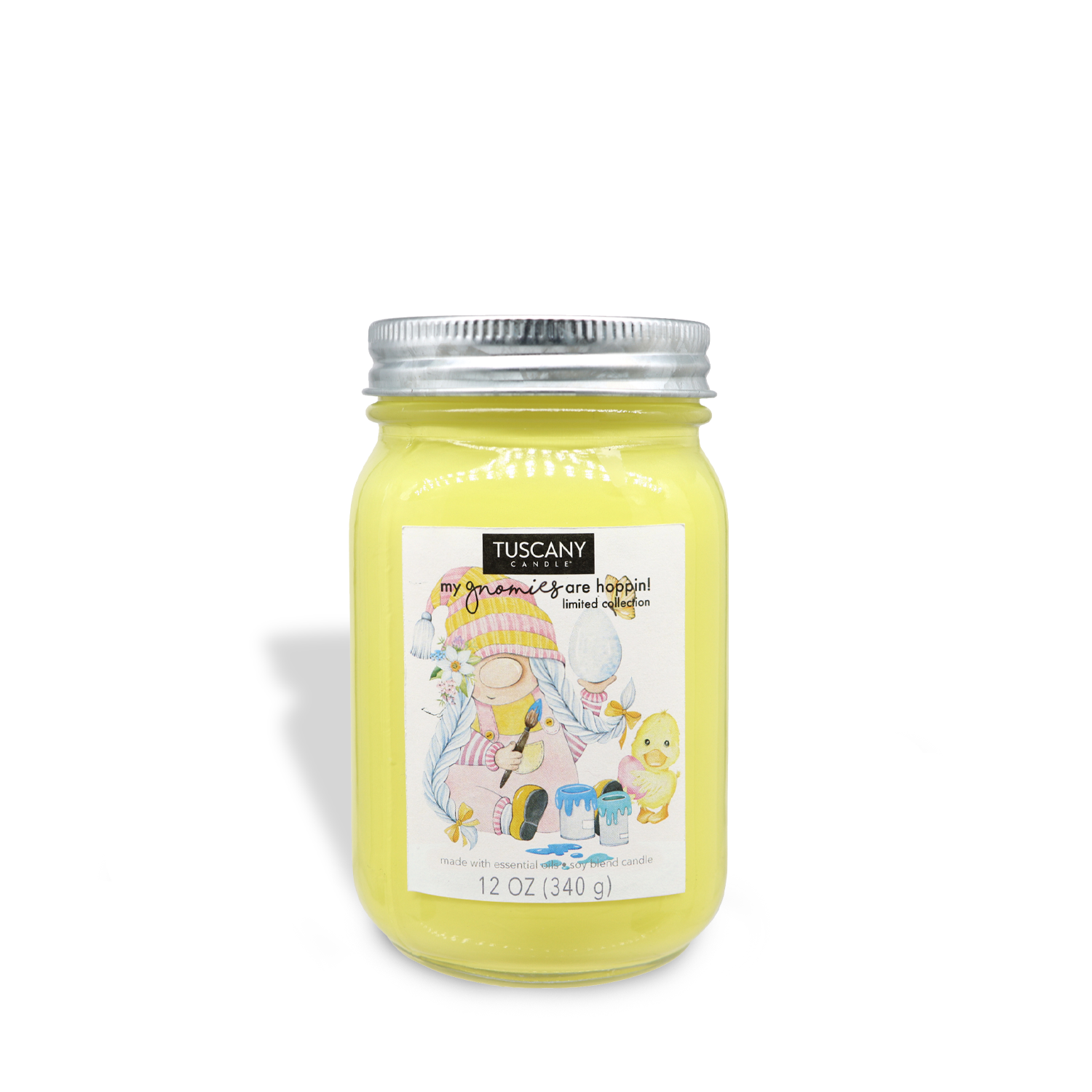 A yellow Eggstra Artistic Gnome (12 oz) candle jar with hints of vanilla on a white background — from the Tuscany Candle® SEASONAL brand.