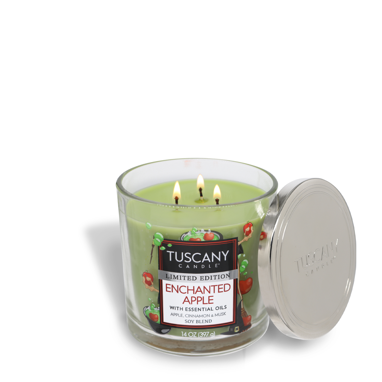 A lit Tuscany Candle® SEASONAL in a glass jar with a metal lid placed to the side. The candle label reads "Enchanted Apple Long-Lasting Scented Jar Candle (14 oz), with essential oils, apple, geranium, musk, soy blend." Experience the captivating fragrance notes crafted from premium satin wax.