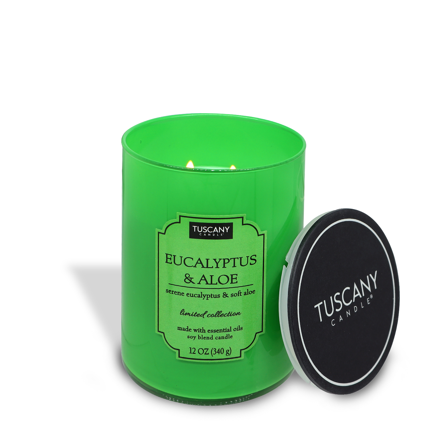 A lit green Tuscany Candle® EVD Eucalyptus & Aloe (12 oz) candle in a glass jar from the Colorsplash collection with the lid placed beside it.